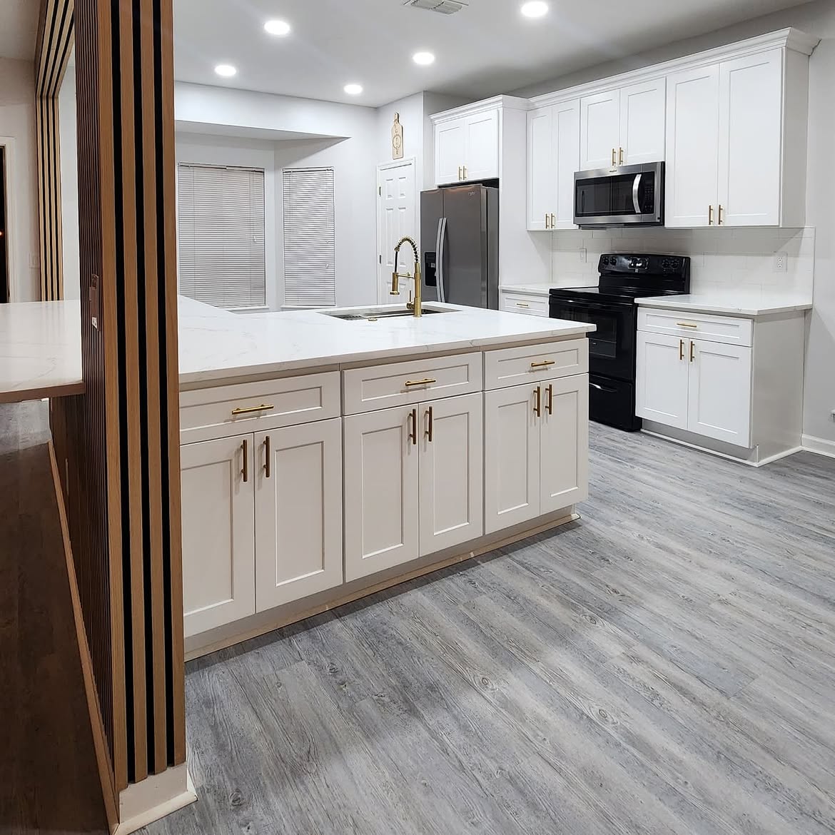 Modern kitchen remodel by Extreme Company USA in Jacksonville FL — white shaker cabinets, quartz waterfall island, stainless steel appliances