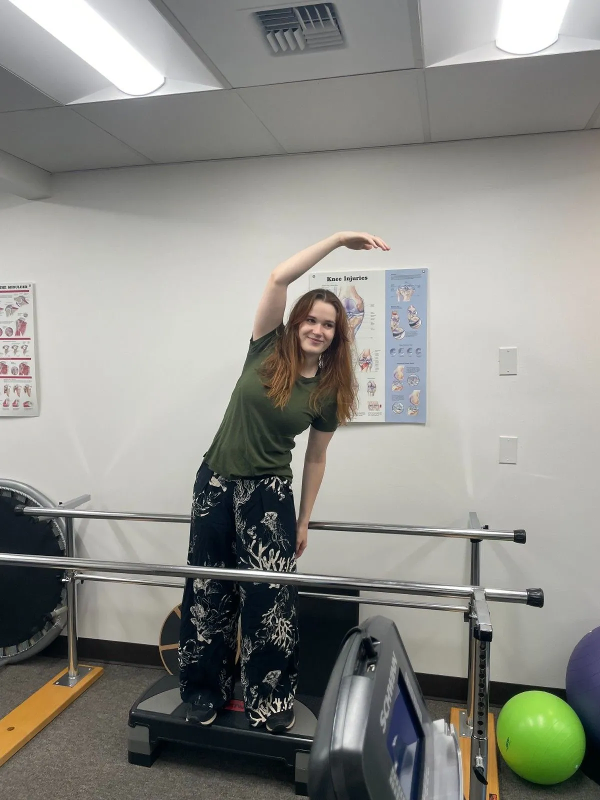 Physical therapist helping patient with post-operative exercises