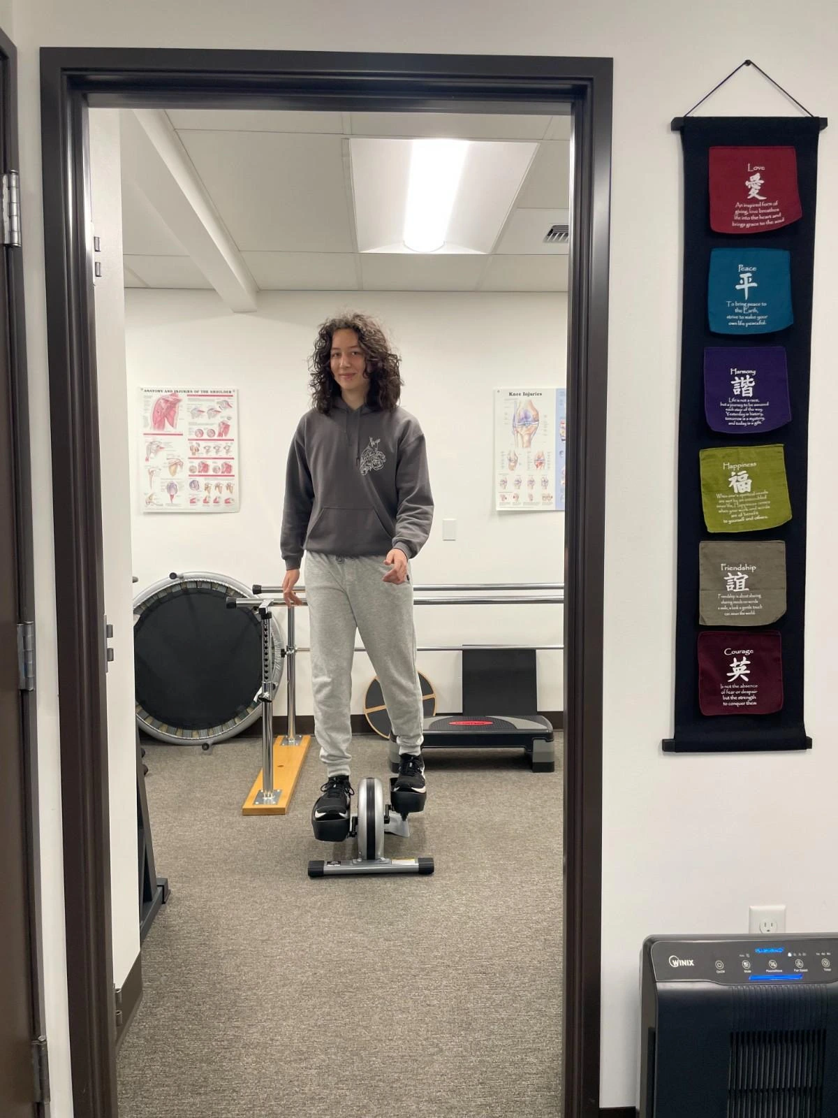 Therapy room with treatment table and rehabilitation parallel bars