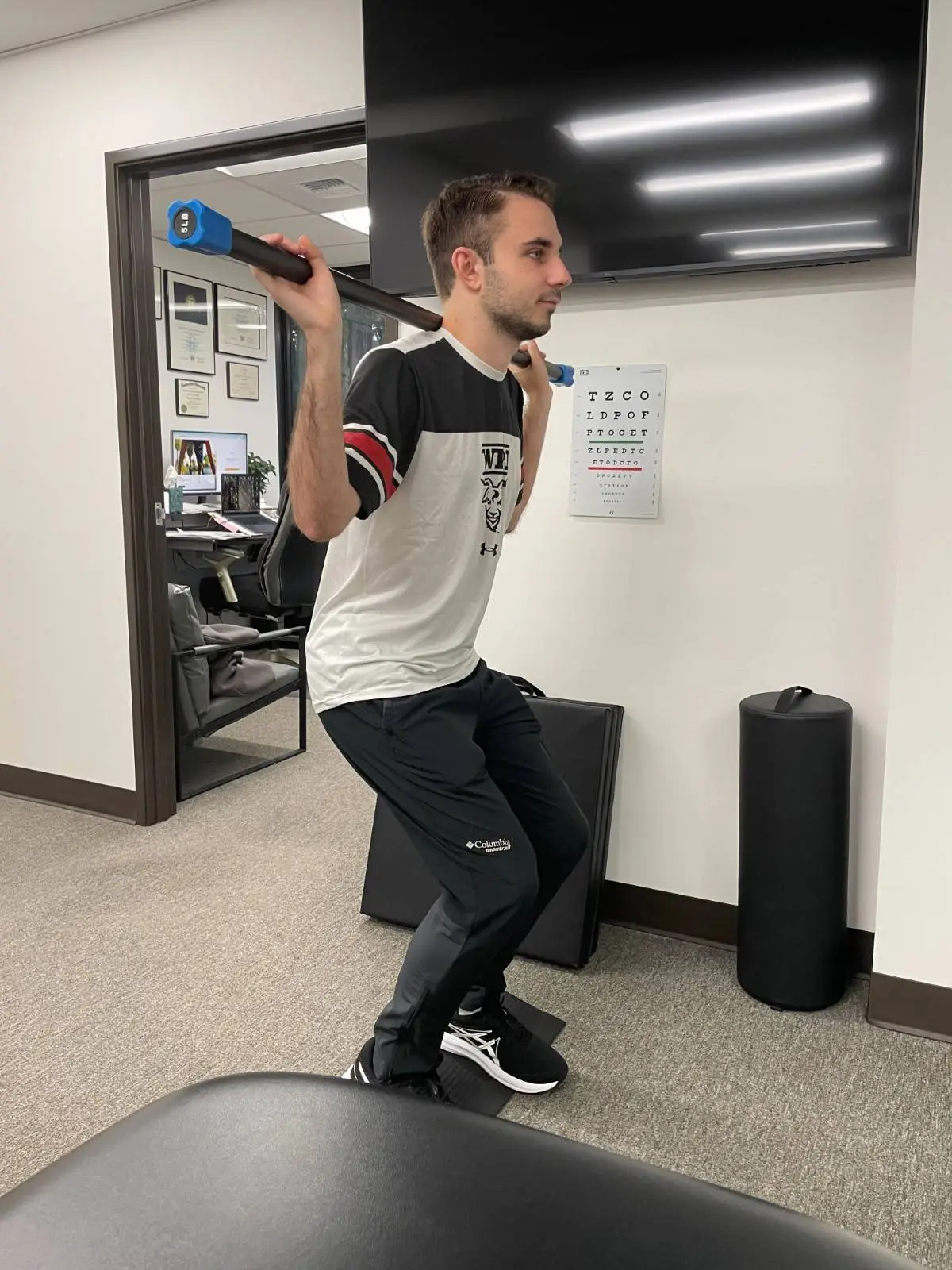 Patient doing exercises on a stepper machine in the therapy gym