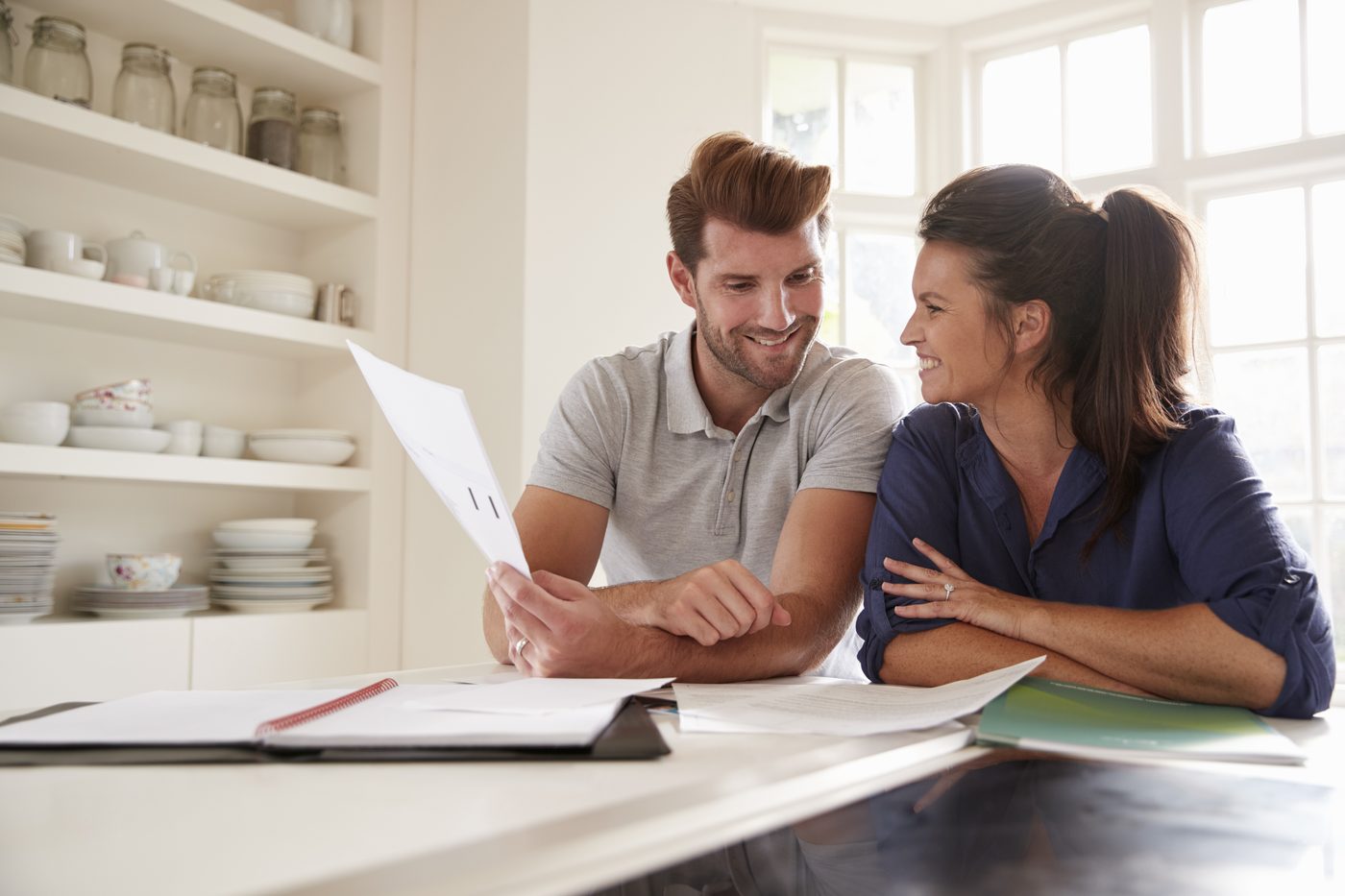 A couple going through paperwork together at home