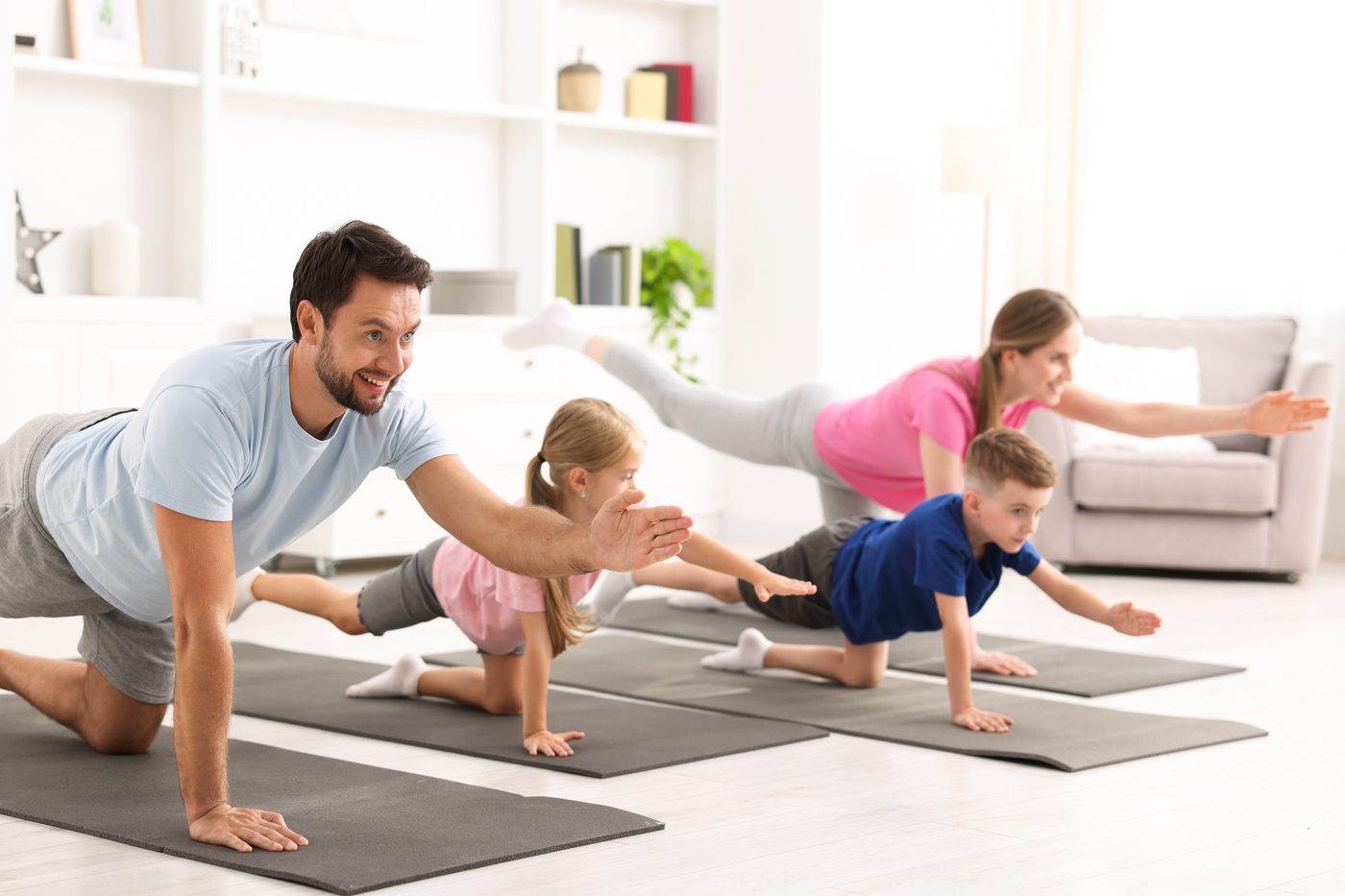 A family exercising together at home
