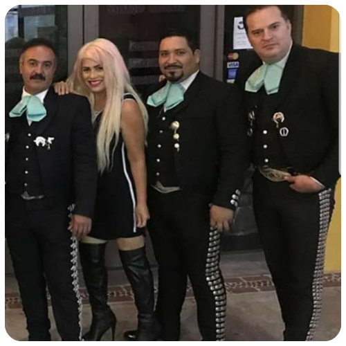 Mariachi Juvenil Grullense posing with a celebrity guest during a red carpet event performance.