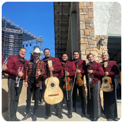 Mariachi Juvenil Grullense live on stage with Jorge Medina and Luis R. Conriquez during a televised music awards show.