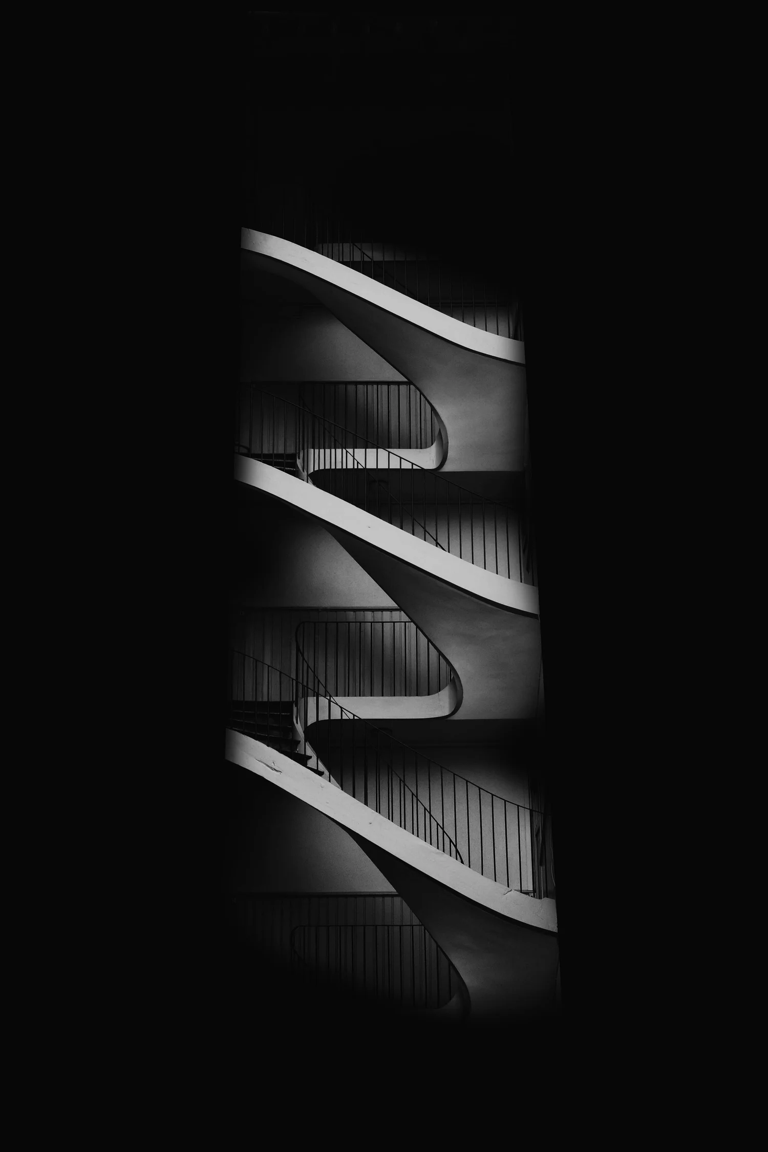 Black and white spiral staircase viewed from the side