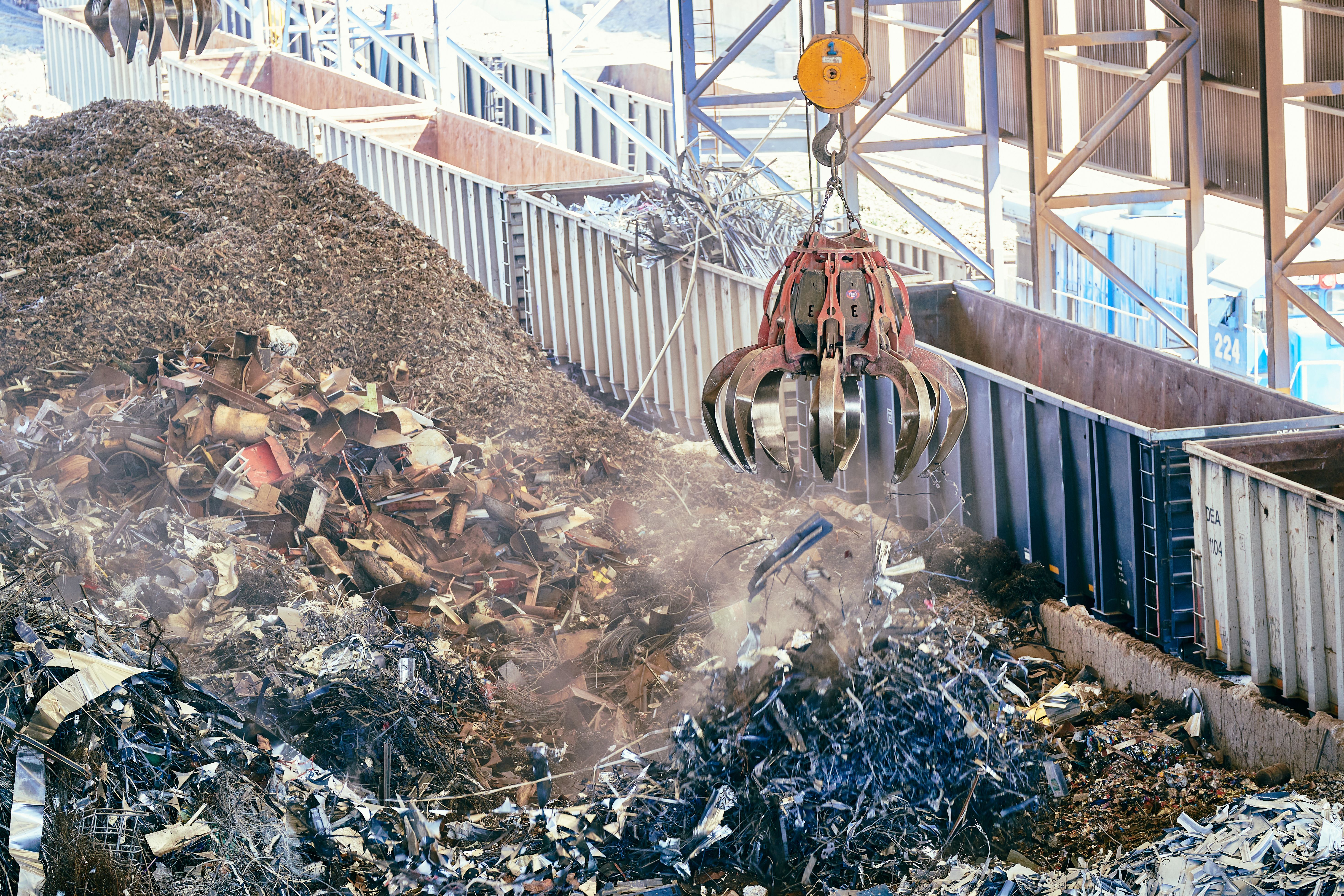 Grab crane handling mixed waste at a processing site