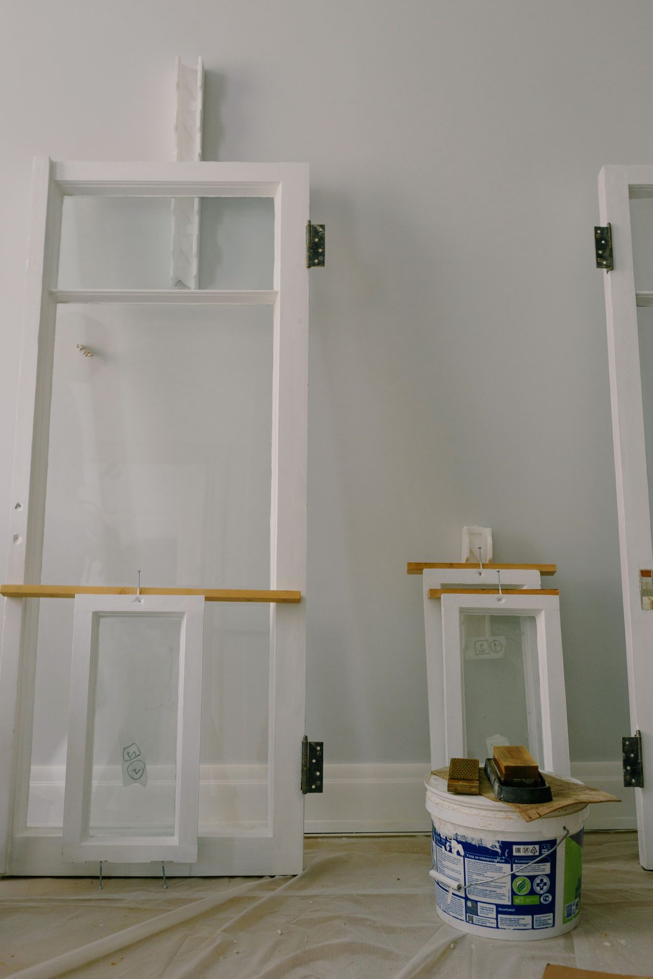 Interior mid-renovation with window frames and paint