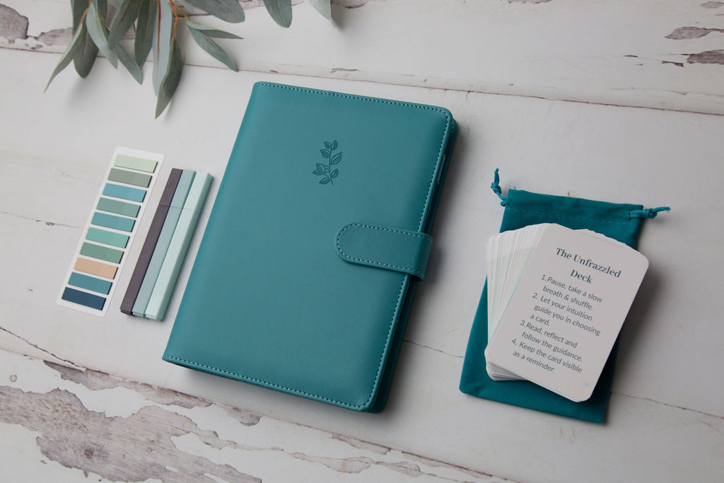 The Unfrazzled Planner and reflection cards arranged in natural light