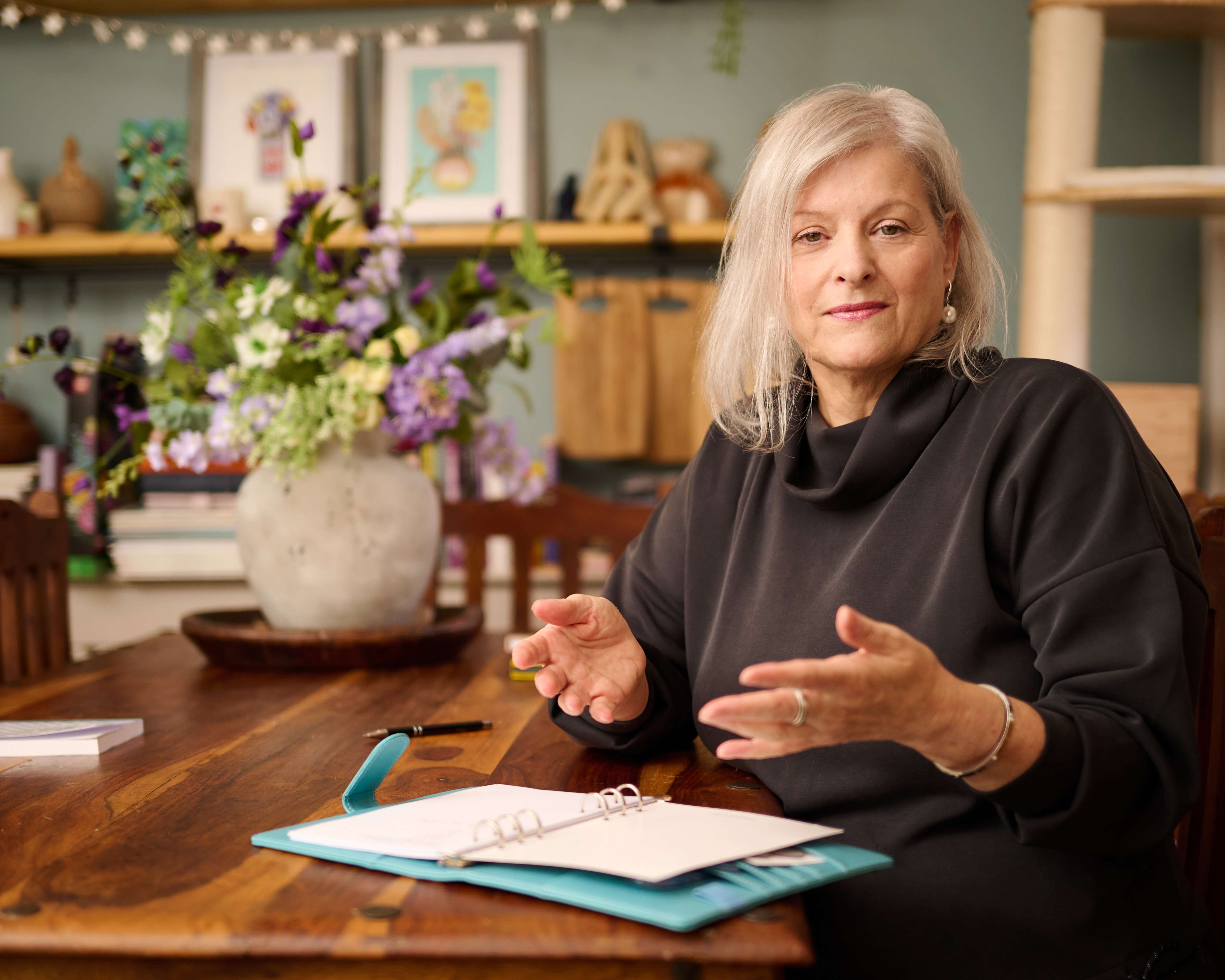 Lisa Negus in conversation with a teal notebook