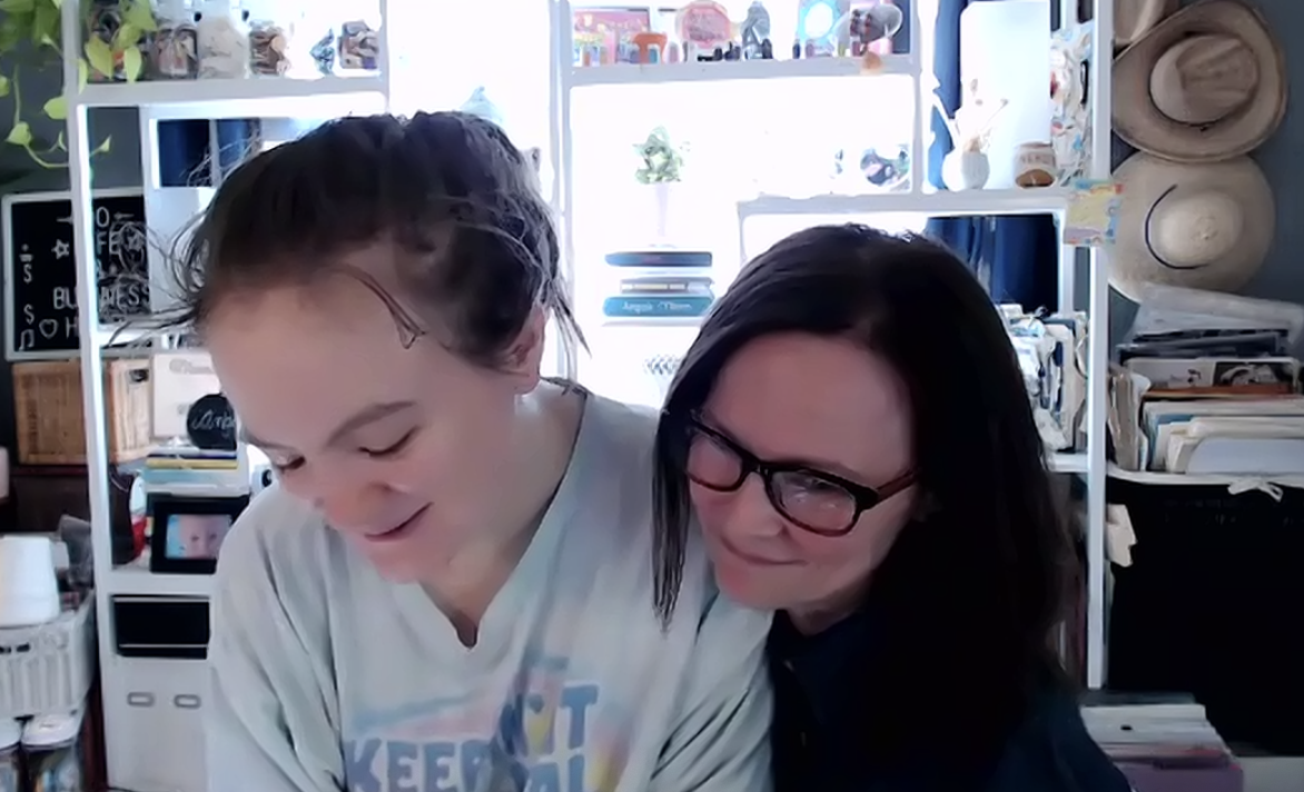 mother and daughter smiling while listening to their Happy Heart Song for the first time