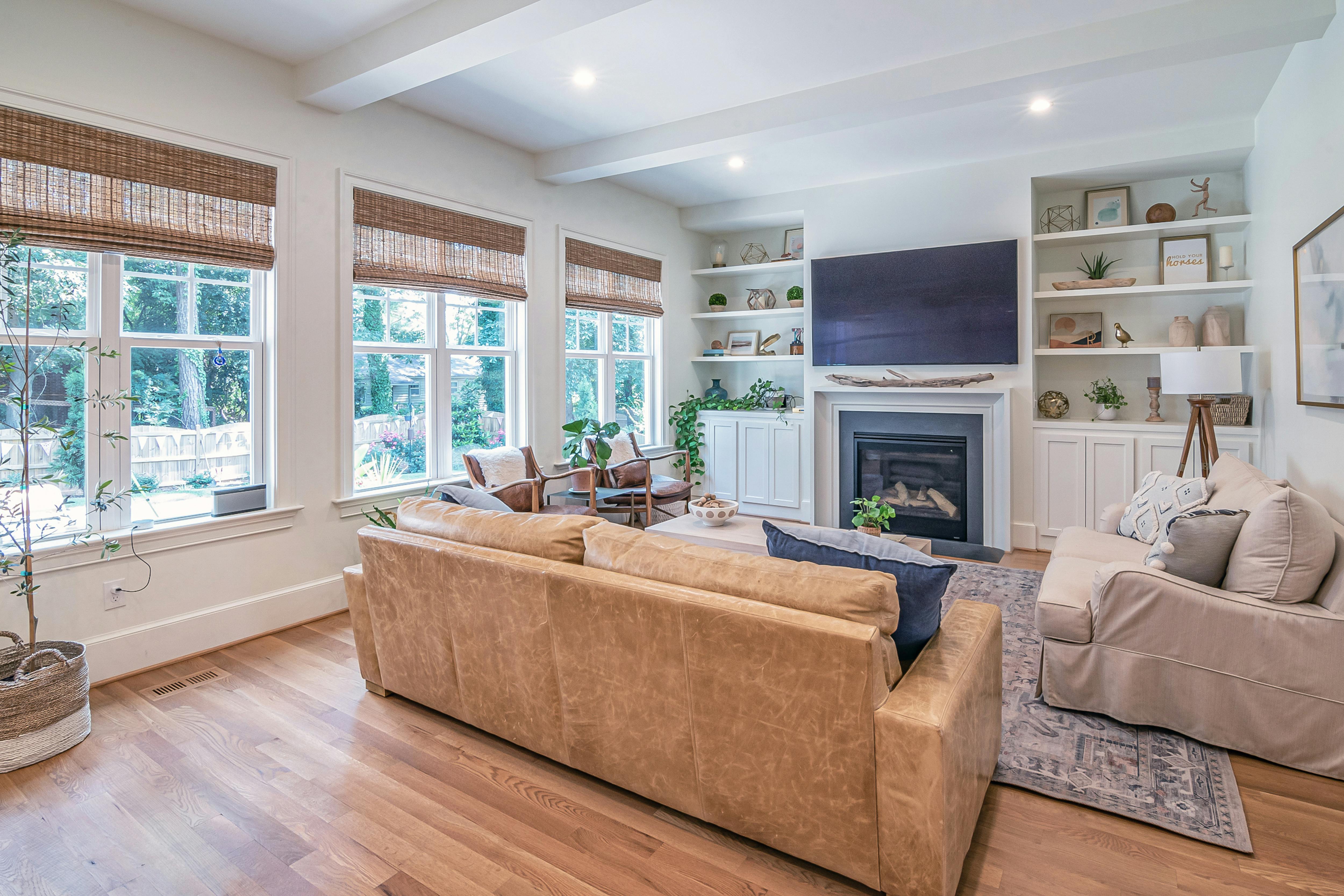 Open windows and clean living room prepared to remove odors before a showing.
