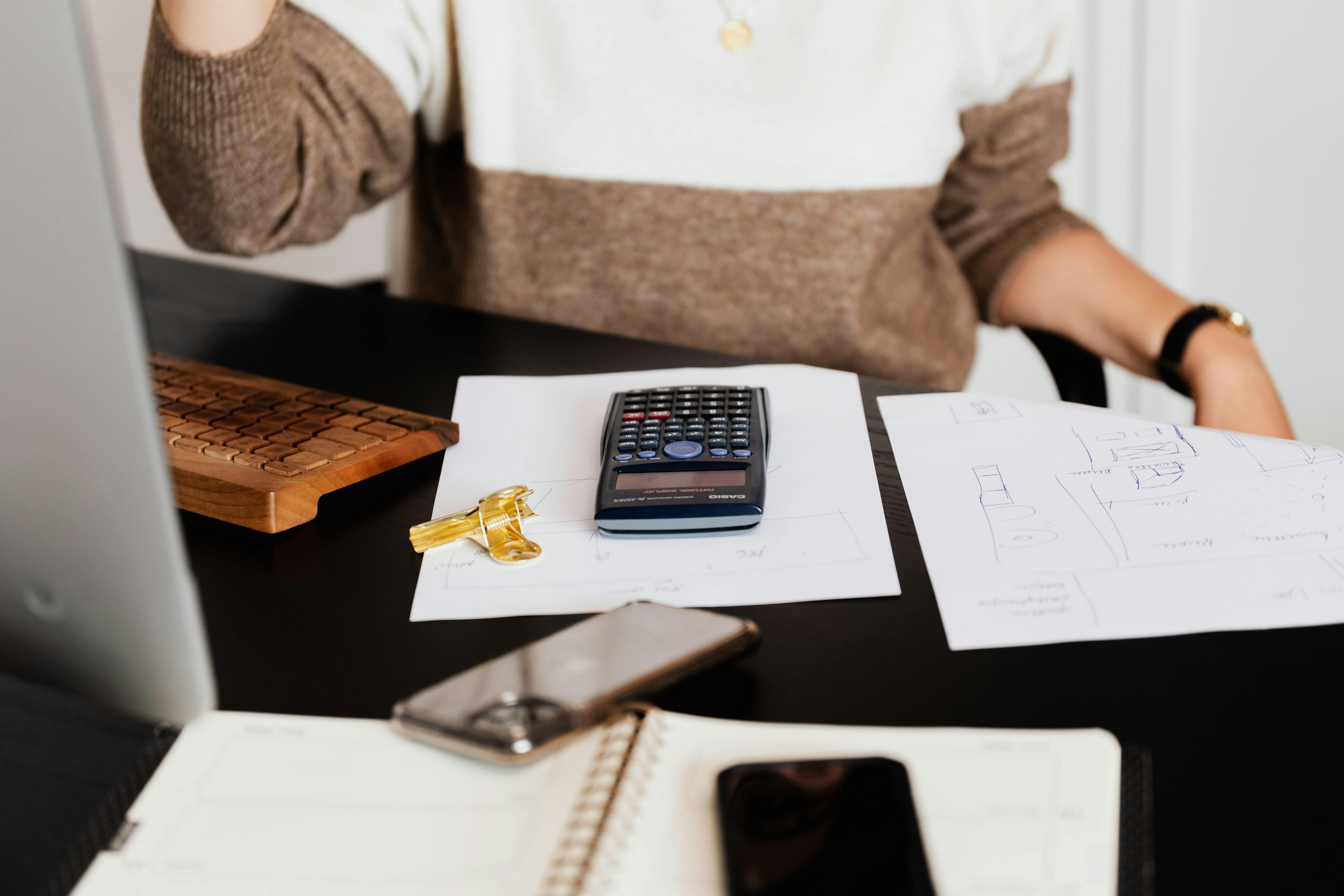 Home seller reviewing real estate paperwork and questioning costly agent advice.