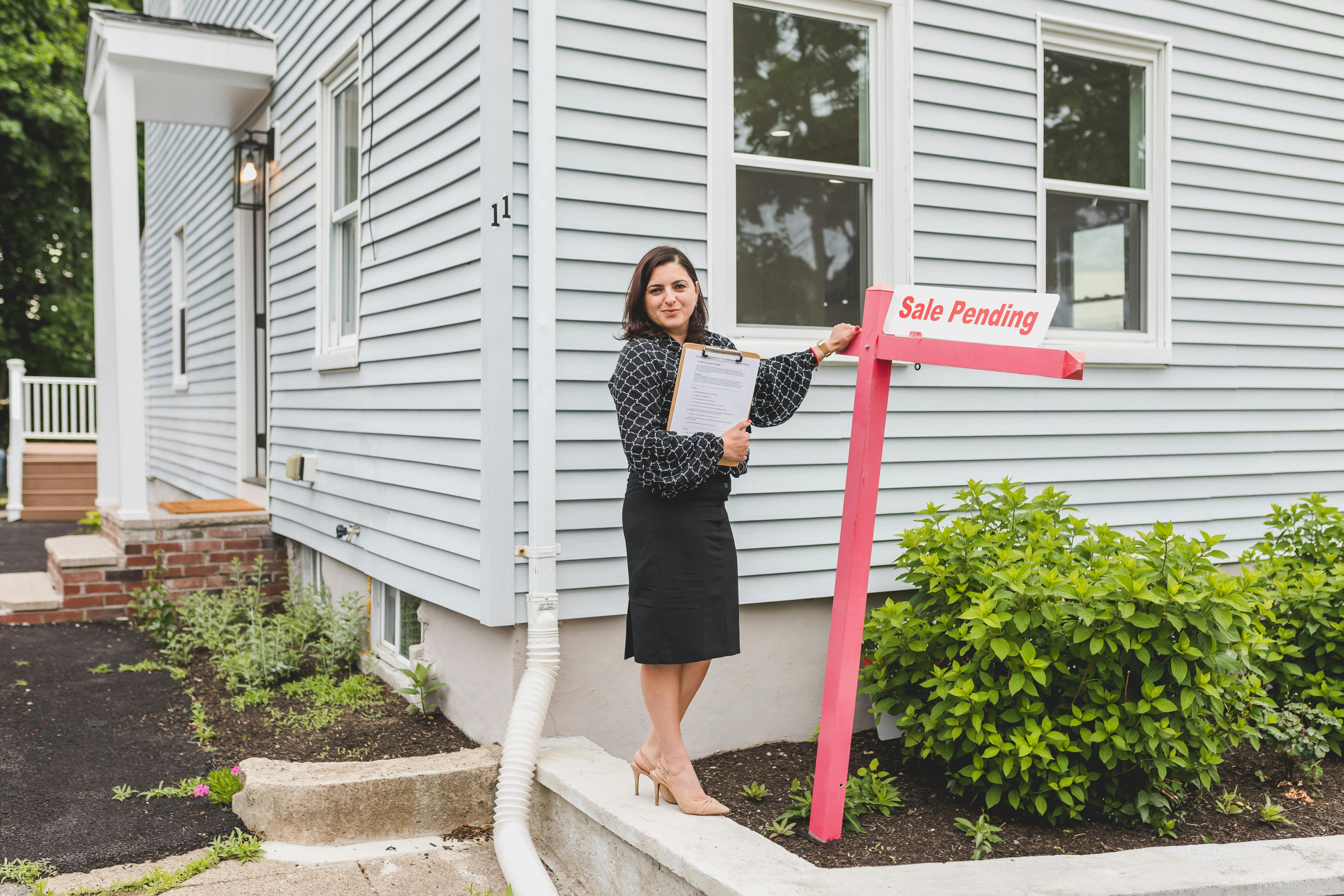 Home seller reviewing pricing strategy before listing a house for sale. Home seller reviewing pricing strategy before listing a house for sale.