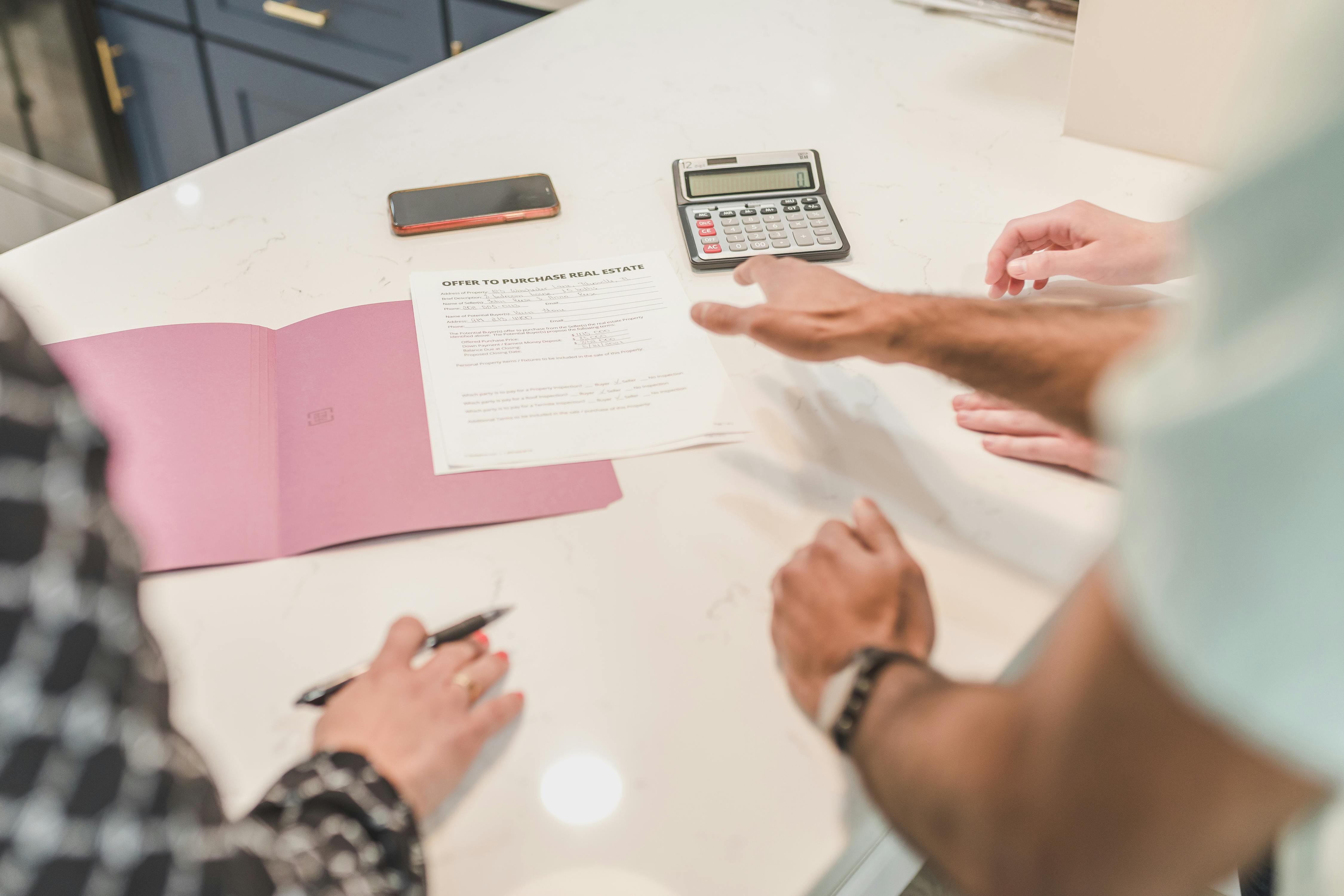 Home seller reviewing comparable market analysis before setting a listing price. Home seller reviewing comparable market analysis before setting a listing price.