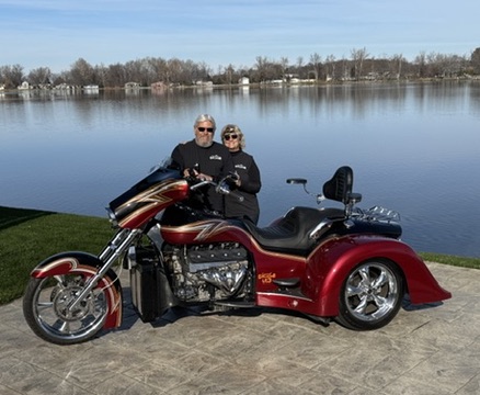 Couple with their Challenger trike at a lake