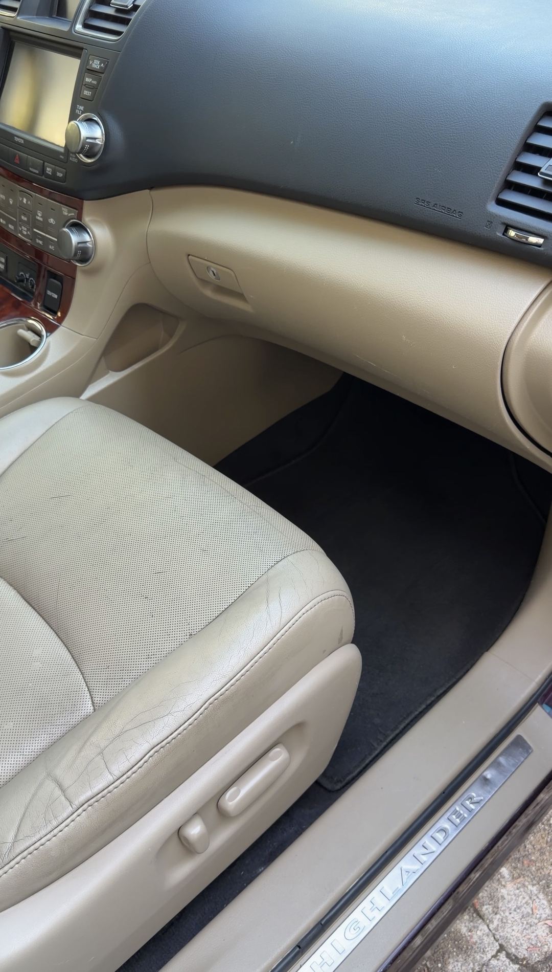 Clean front passenger footwell, glovebox and sill plate of a Toyota Highlander after detailing