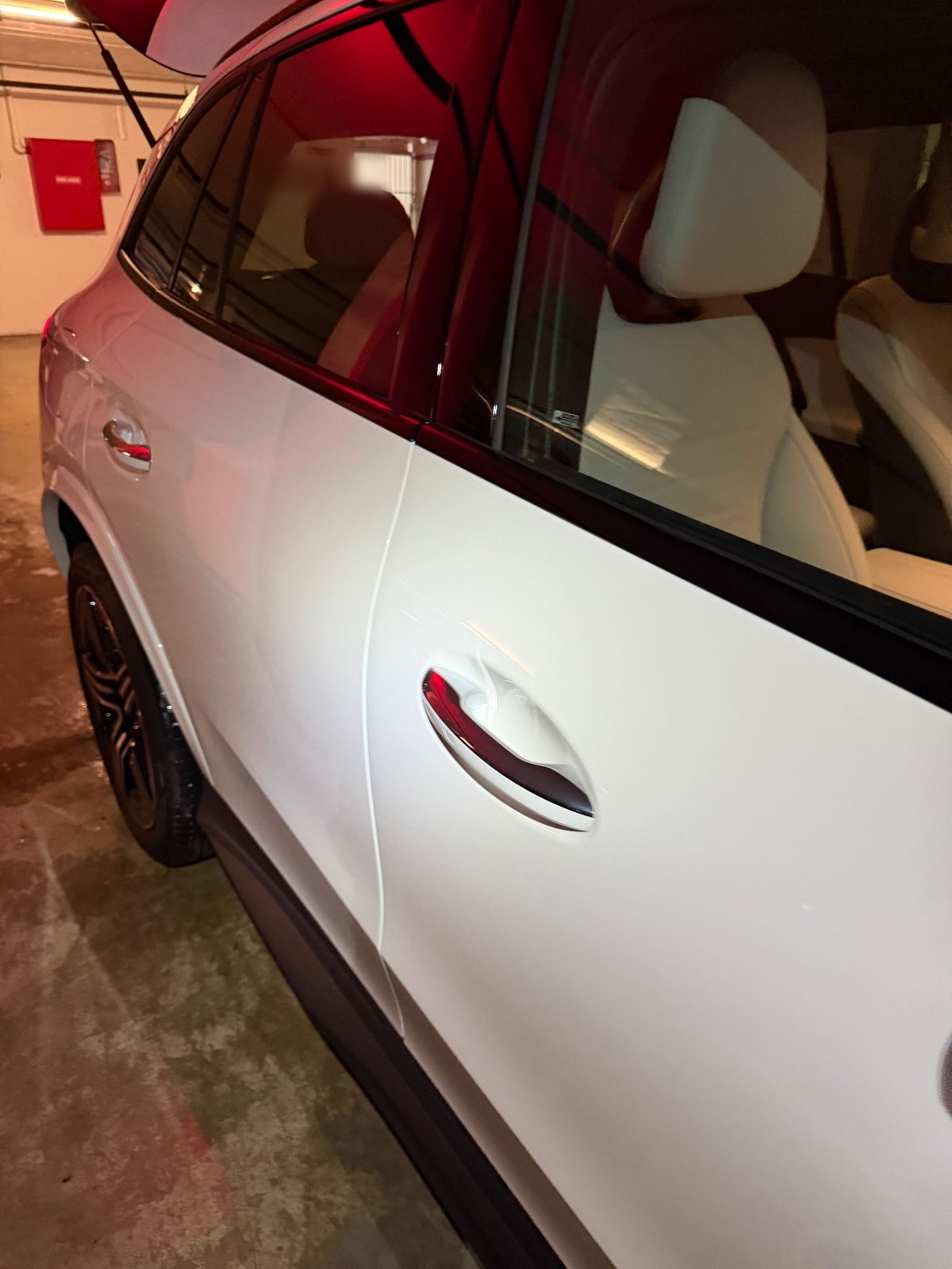 Rear door and quarter of a white Mercedes GLC after washing, clean white paint