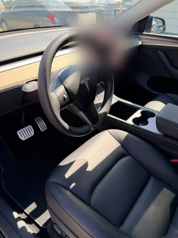 Clean driver seat and cabin of a black Tesla Model Y after an interior detail