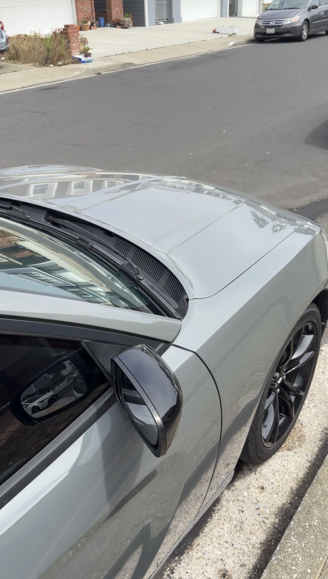 Clean grey Dodge Charger hood and front fender after an exterior detail