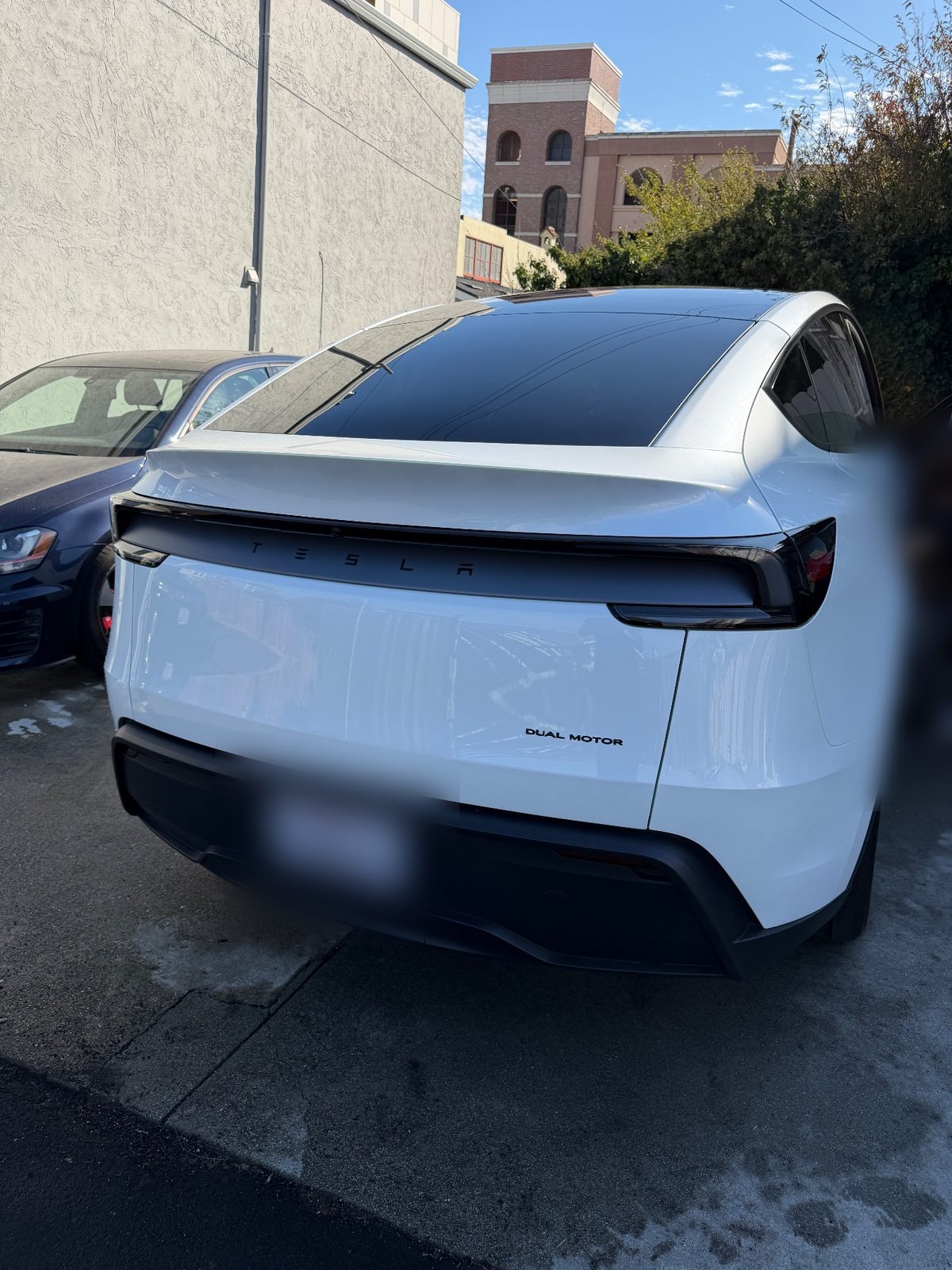 White Tesla Model Y, rear three-quarter, after a full mobile detail in South San Francisco