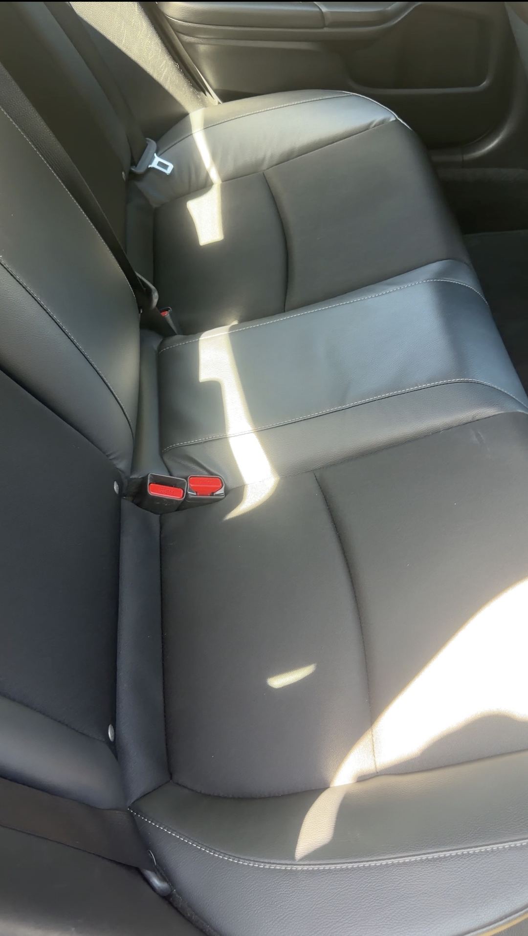 Clean rear bench seat of a Honda Civic after steam cleaning and extraction