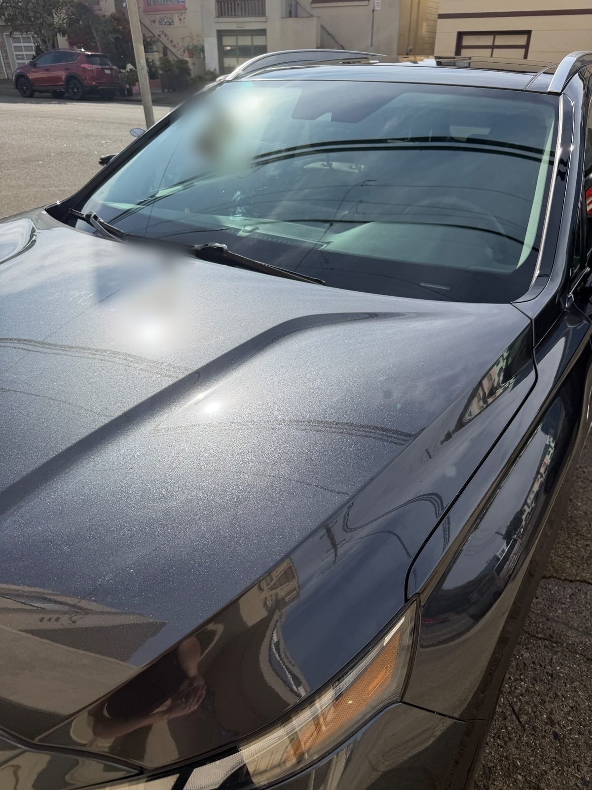 Clean hood and windshield of a dark grey Hyundai Santa Fe after detailing