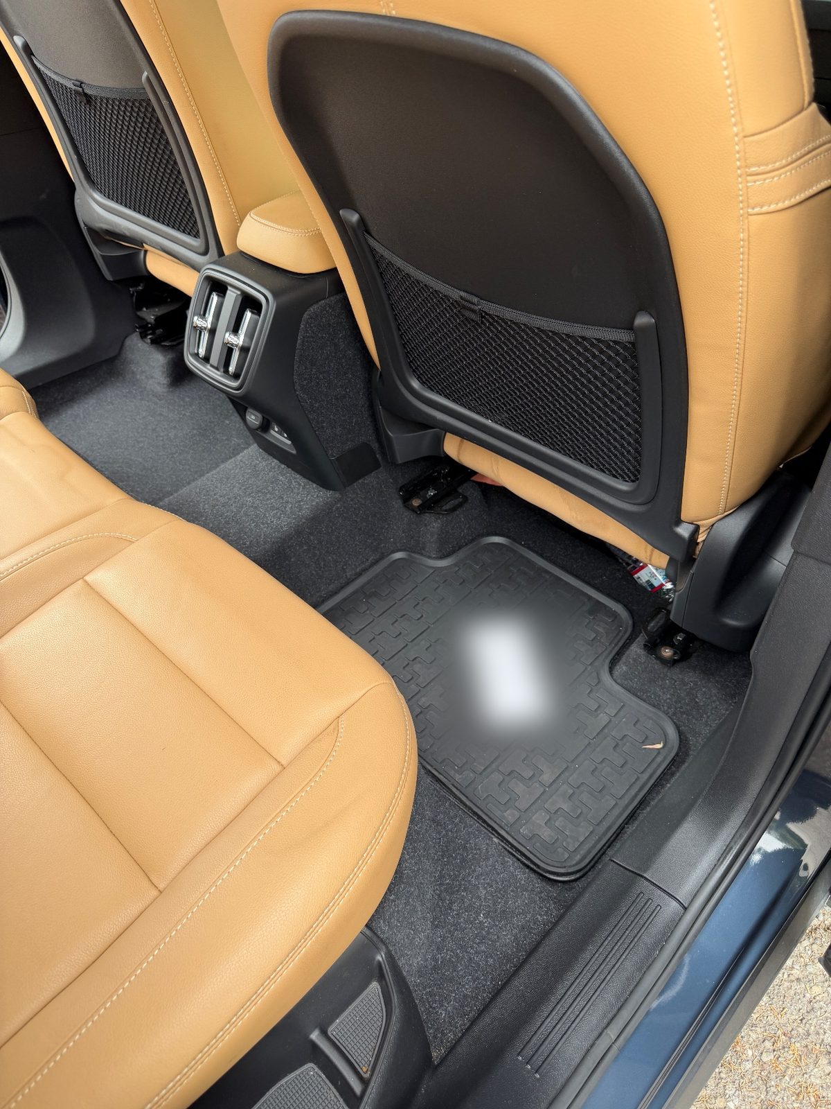 Rear passenger-side footwell of a Volvo XC40 before detailing