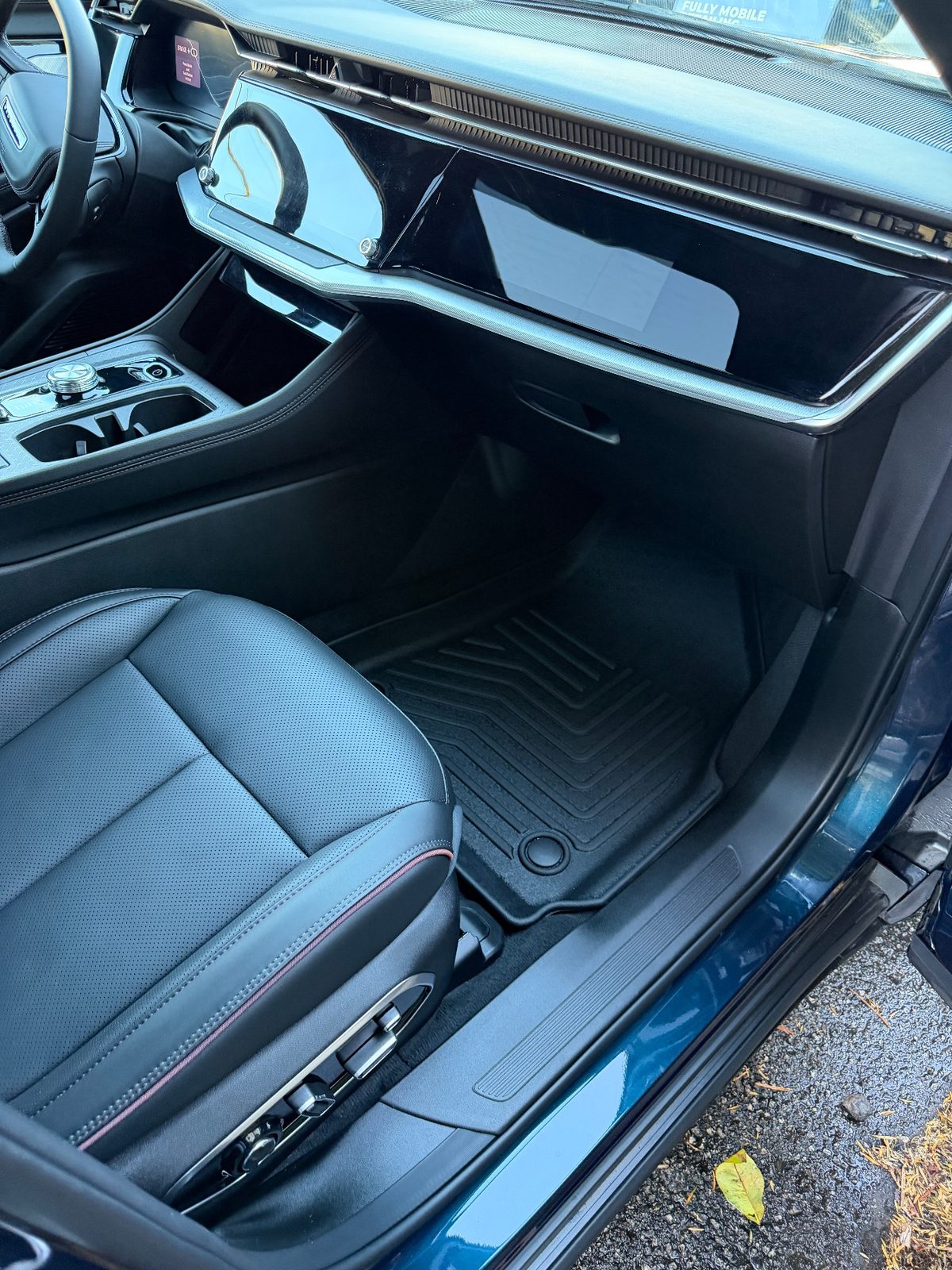 Clean passenger footwell of a Jeep Wagoneer S after detailing