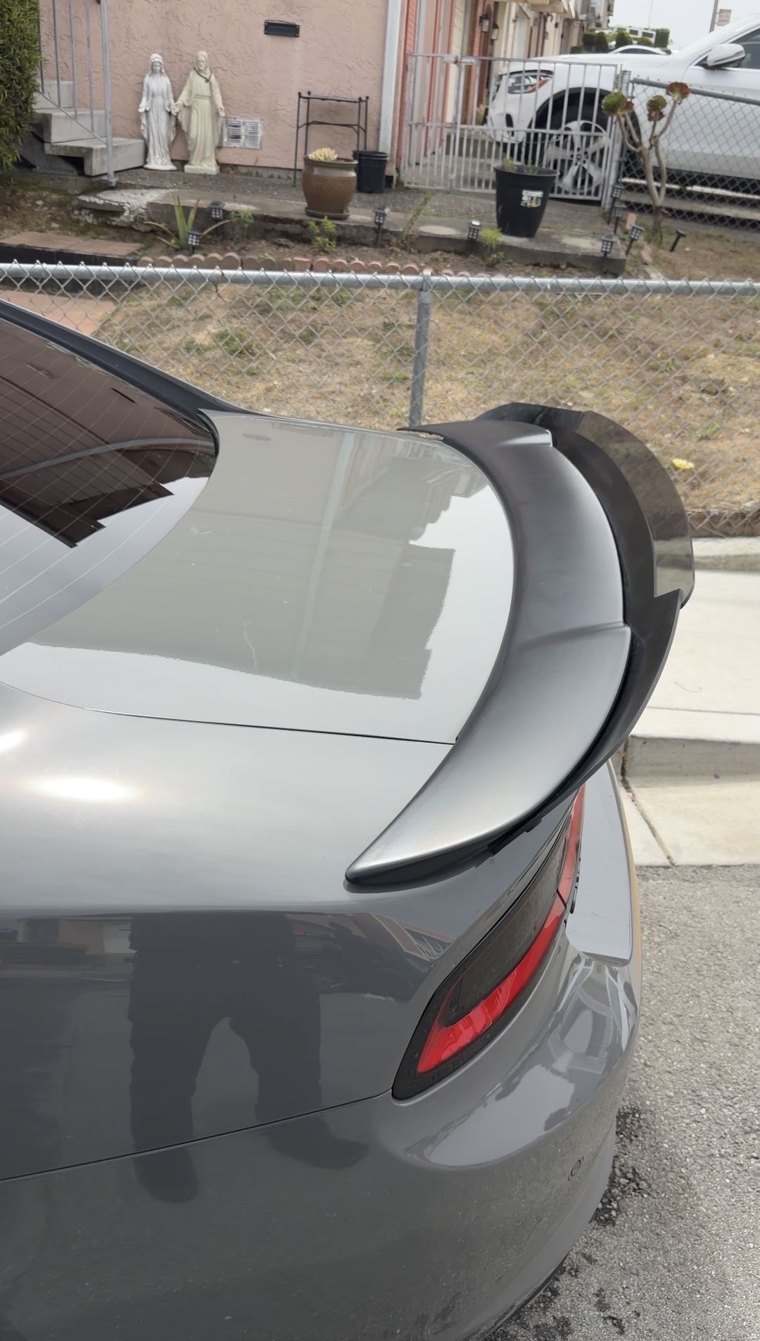 Clean grey Dodge Charger decklid and black rear spoiler after an exterior detail