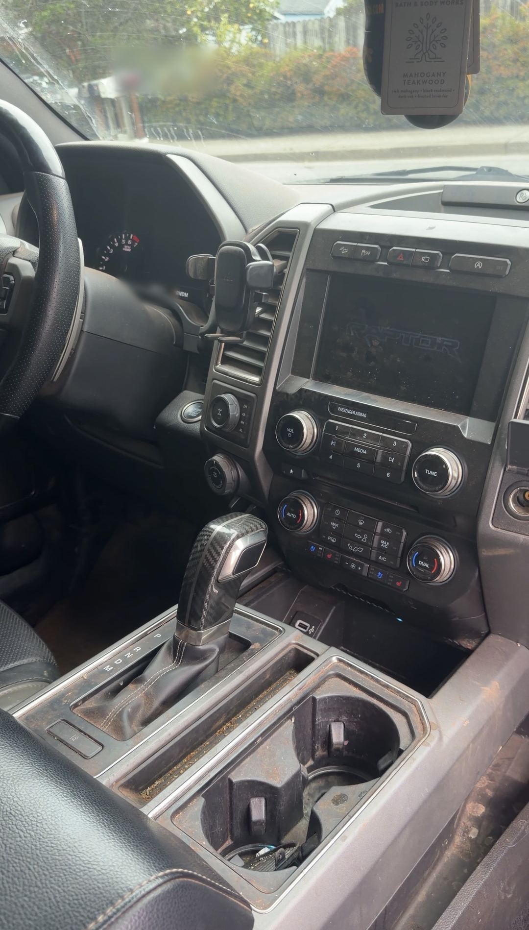Dash and centre console of a Ford F-150 Raptor before an interior detail
