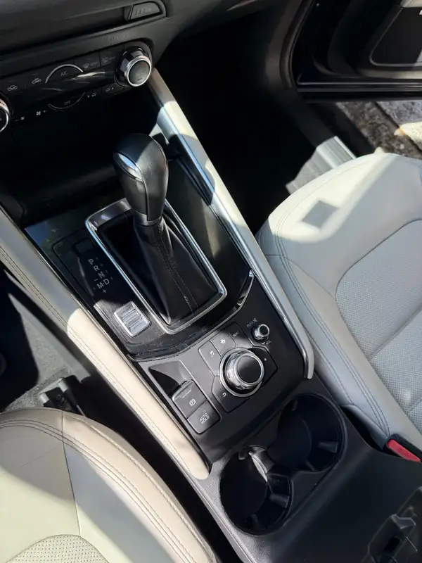 Clean centre console of a dark blue Mazda CX-5 after detailing, cupholders and shifter surround spotless