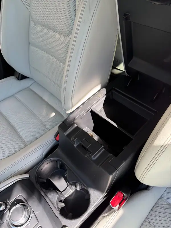 Clean open centre armrest and cupholders of a Mazda CX-5 after detailing