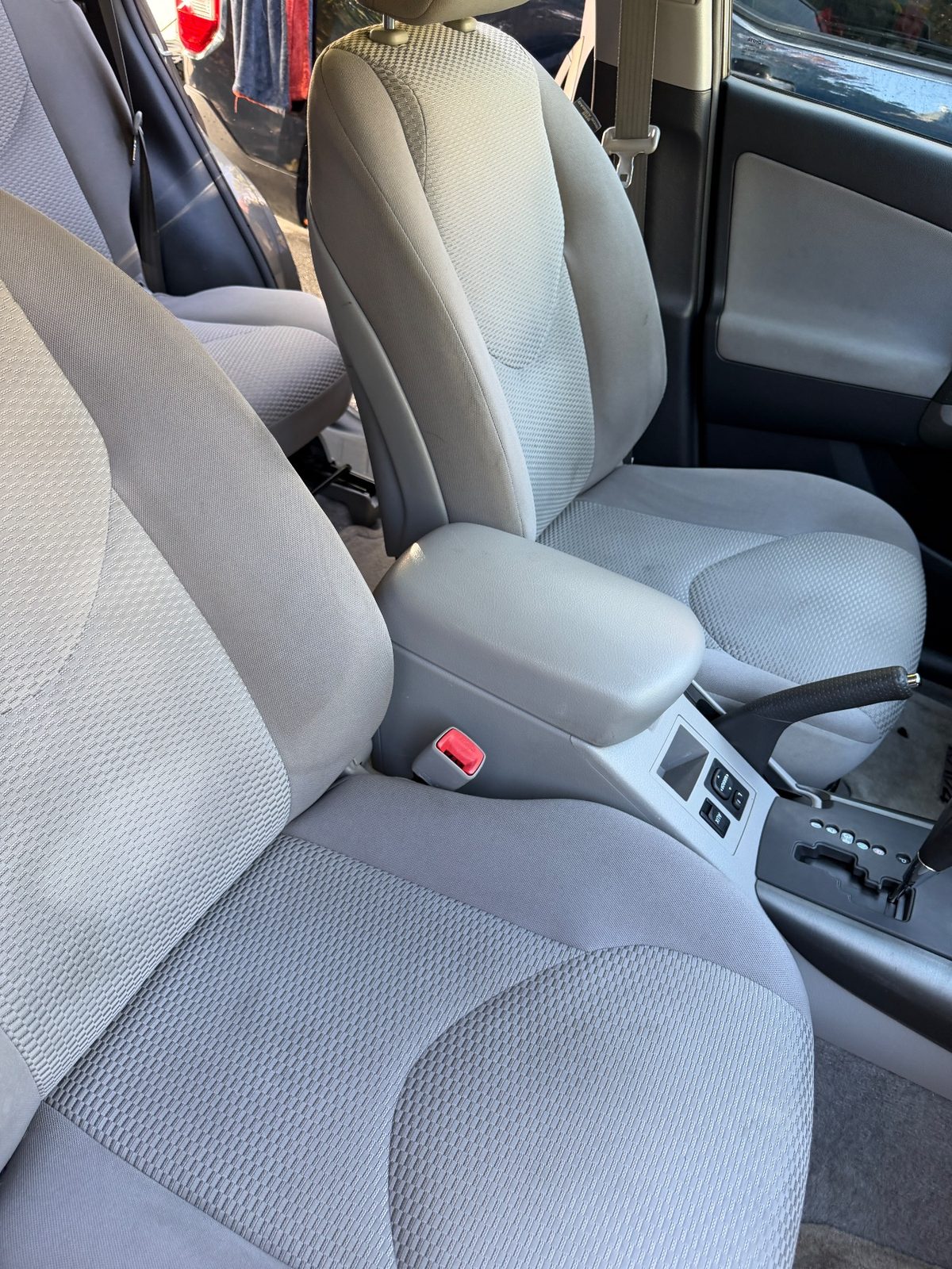 Clean front seats and console of a 2011 Toyota RAV4 after detailing