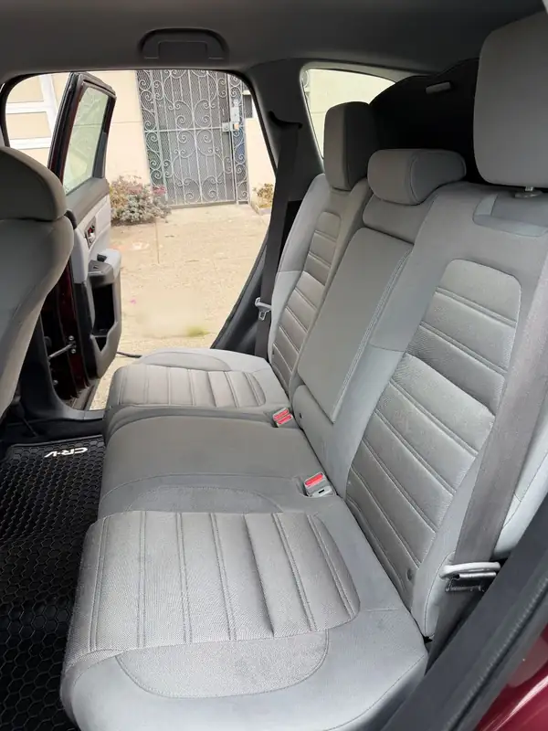 Rear bench of a maroon Honda CR-V after an interior detail, the grey cloth seat clean and stain-free