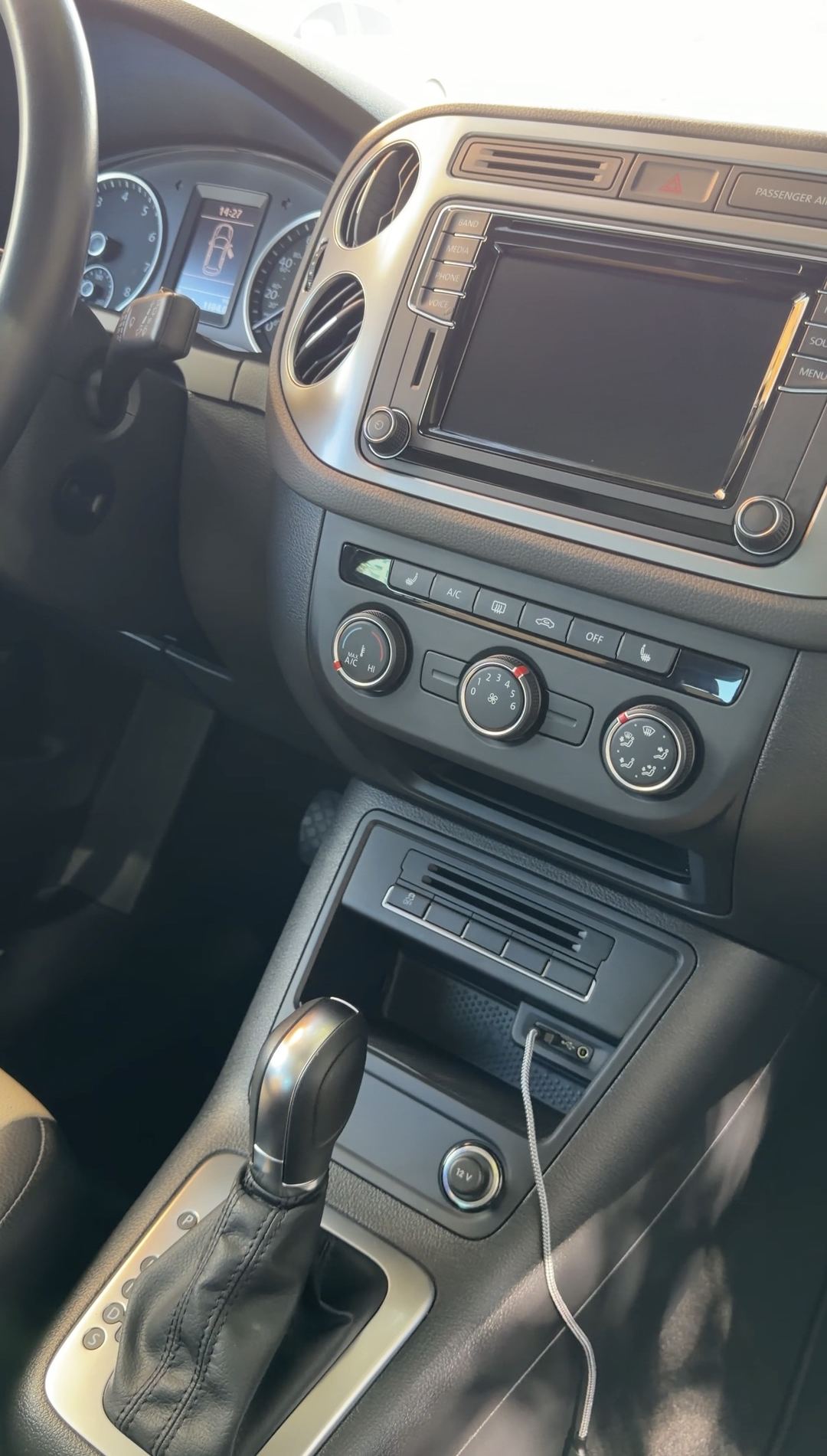 Dashboard and centre console of a VW Tiguan seen from the driver's seat after detailing.