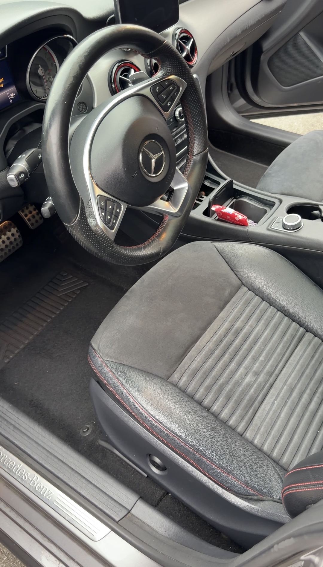 Driver's seat and steering wheel of a Mercedes-Benz CLA250 before interior detailing