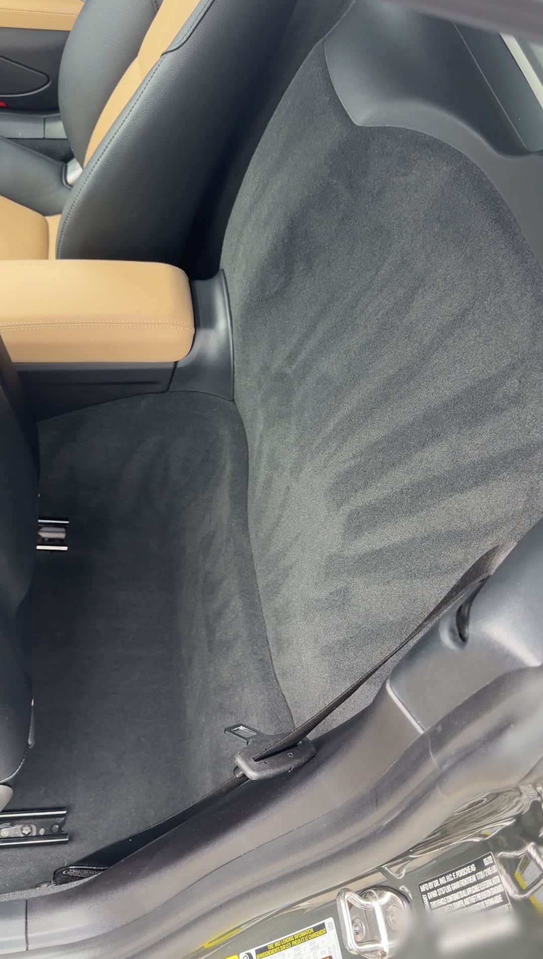 Freshly vacuumed rear carpet behind the seats of a Porsche 718 Cayman S.