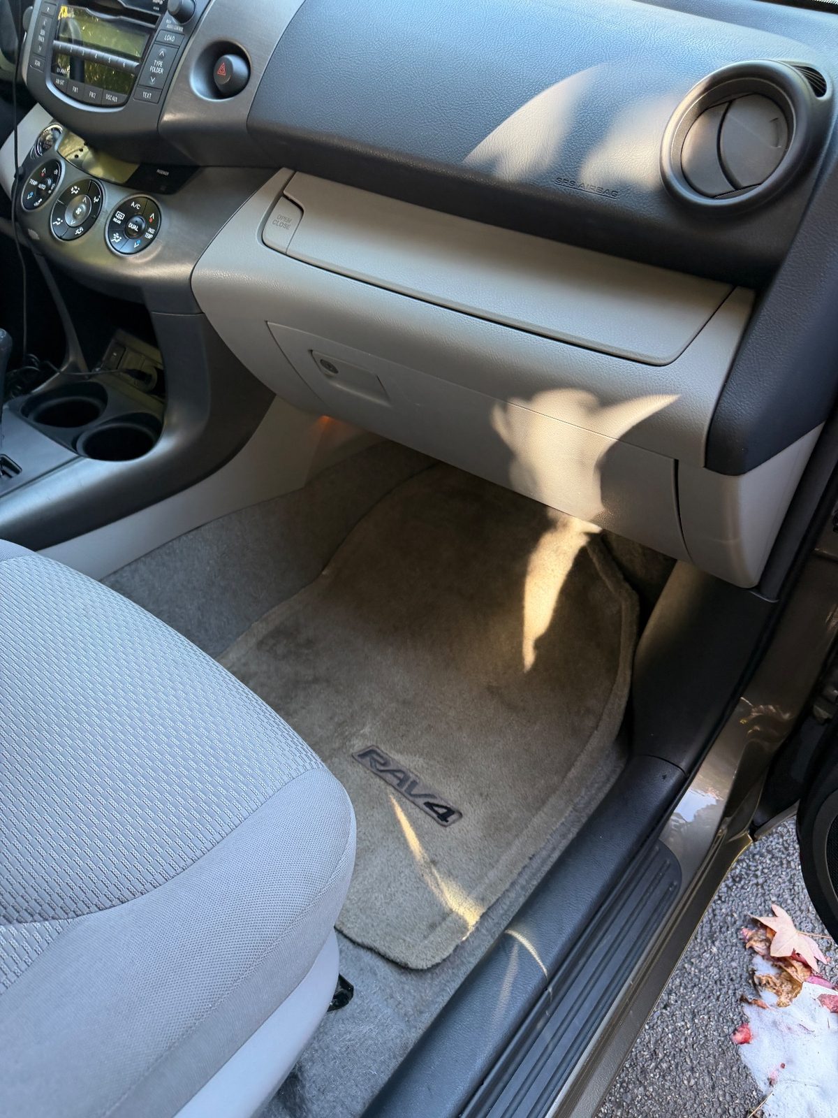 Front passenger footwell of a bronze Toyota RAV4 in the Inner Sunset, San Francisco, after detailing