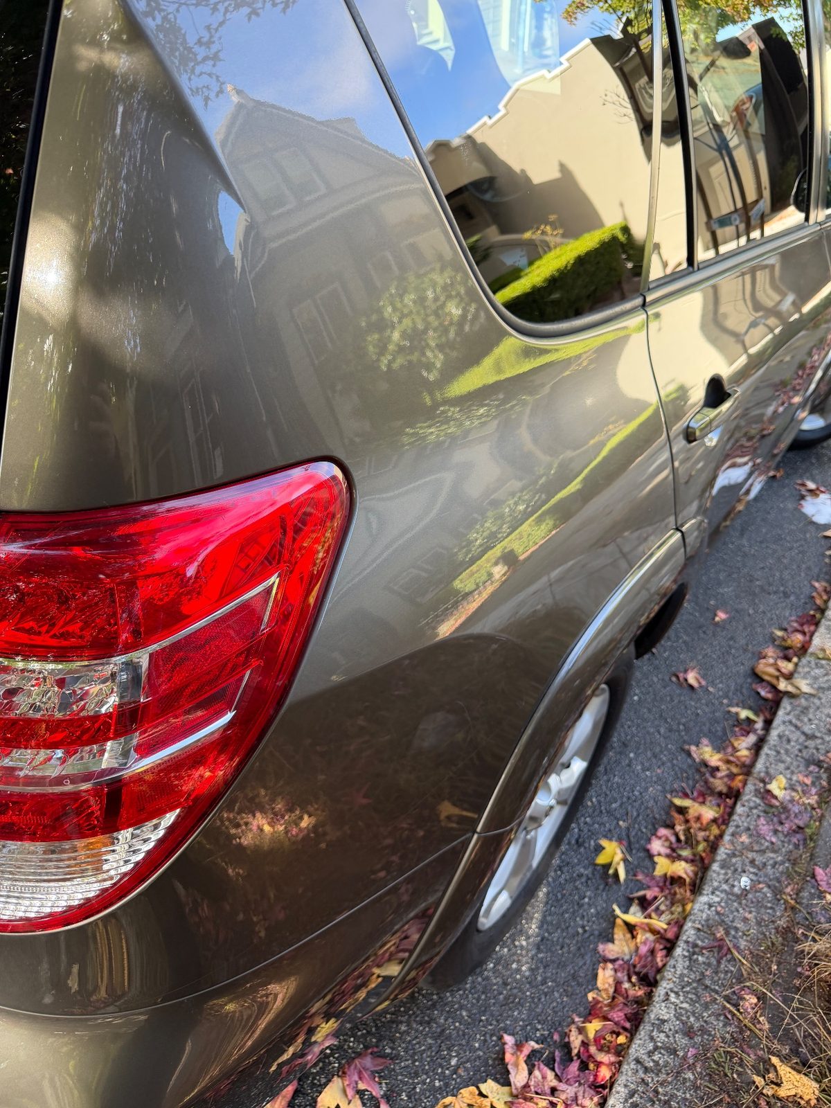 Glossy clean rear quarter of a 2011 Toyota RAV4 after washing