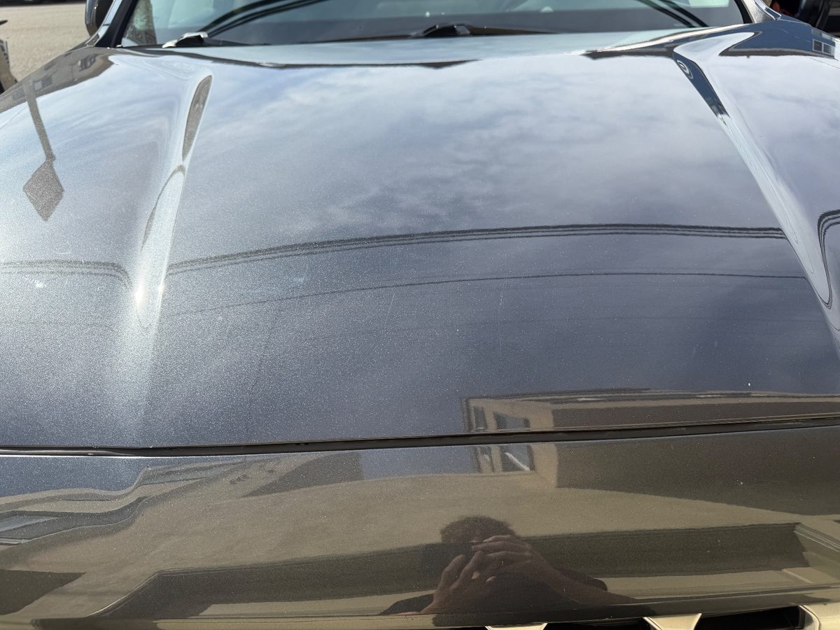 Clean glossy hood of a grey Hyundai Santa Fe after detailing, with the hairline scratches much less visible
