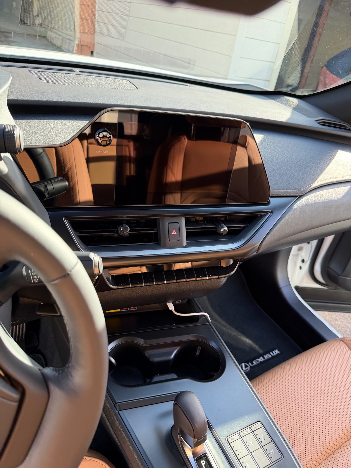 Clean dash and touchscreen of a white Lexus UX with cognac leather after detailing