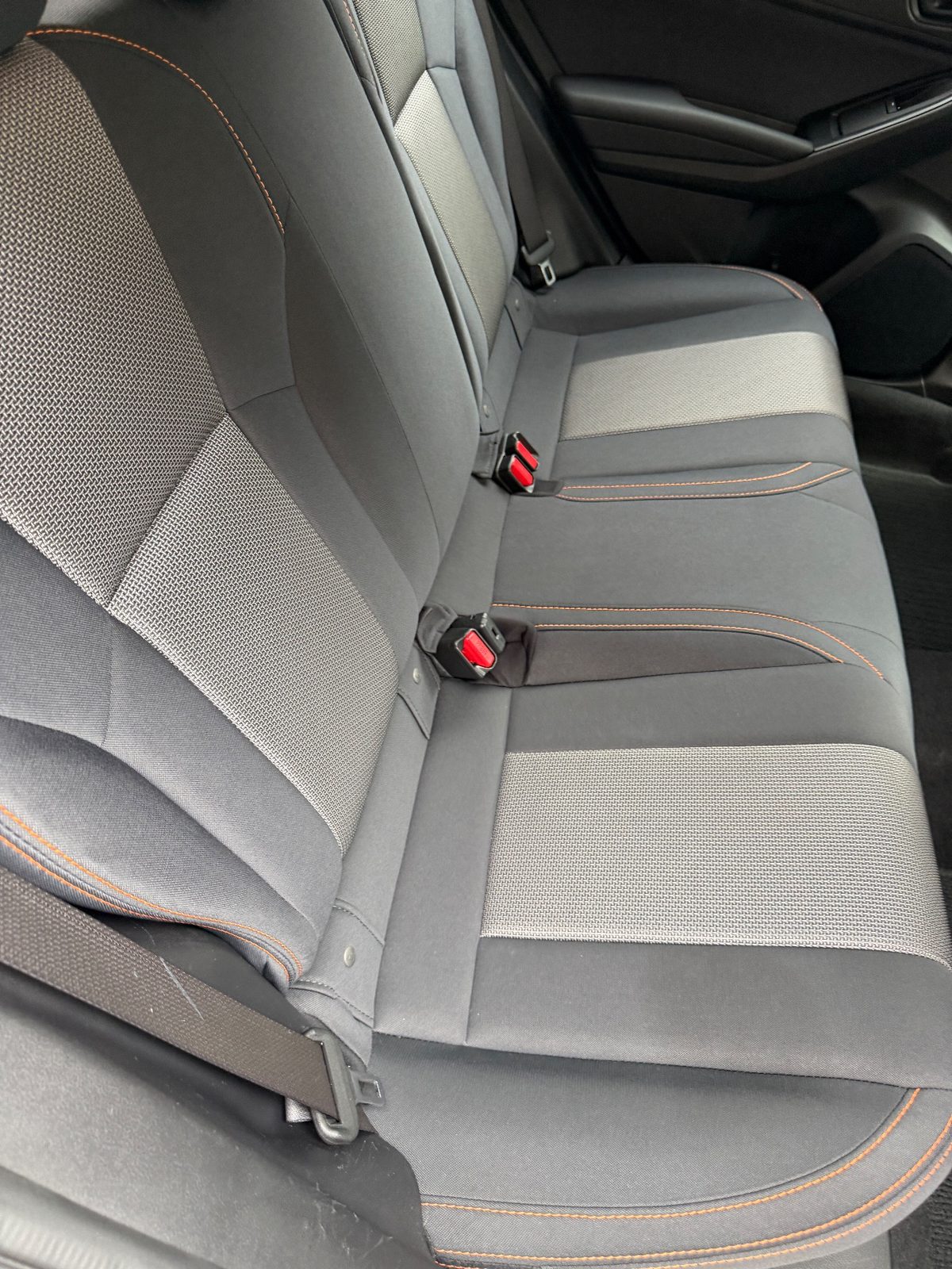 Clean rear bench seat of a Subaru Crosstrek seen from the right rear door