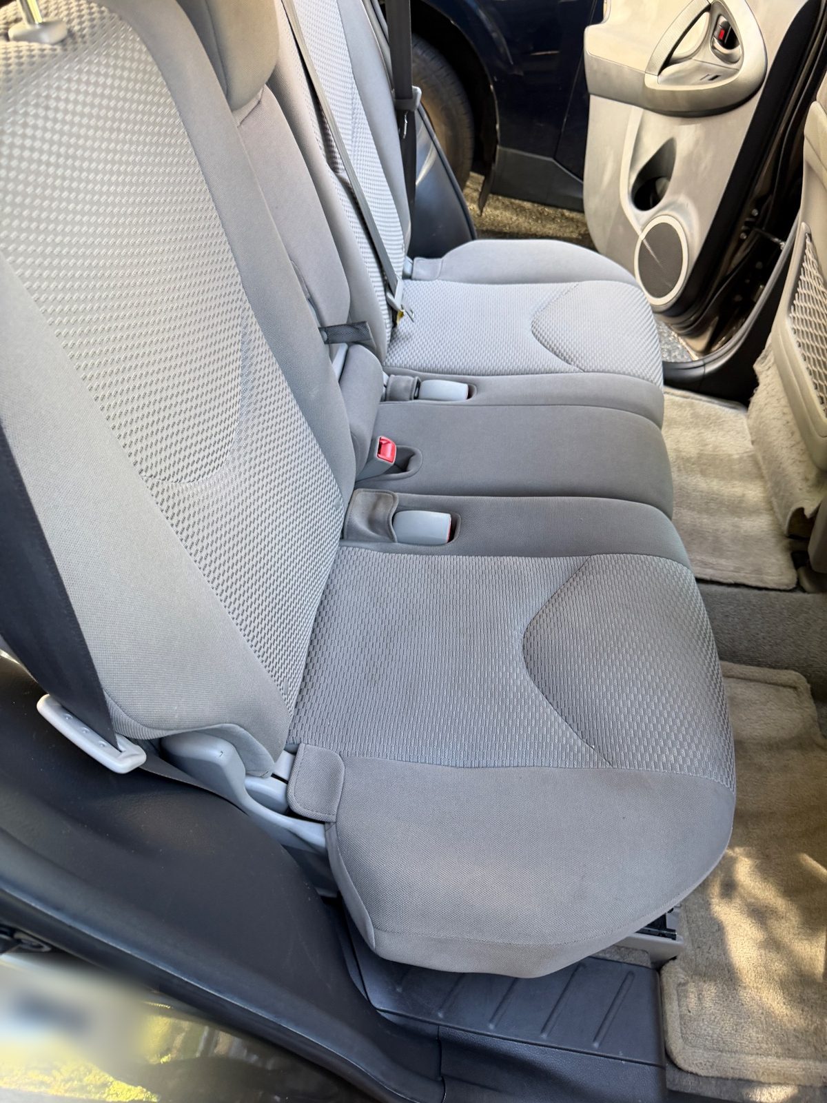 Clean rear bench seat of a 2011 Toyota RAV4 after detailing
