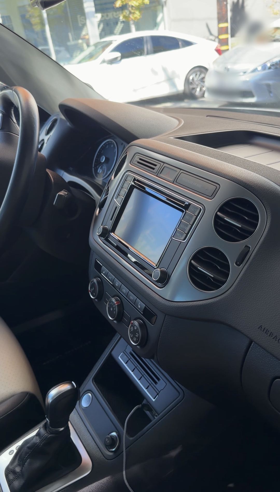 Centre stack and dashboard of a VW Tiguan after detailing, seen from the passenger side.