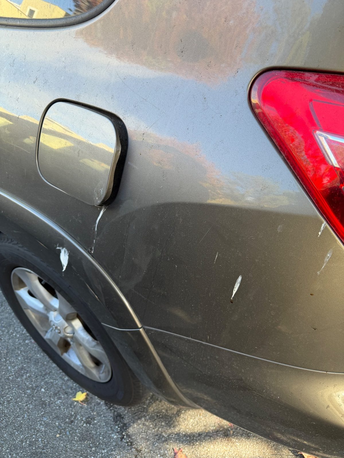 Bird droppings and dust on the rear quarter of a 2011 Toyota RAV4 before washing