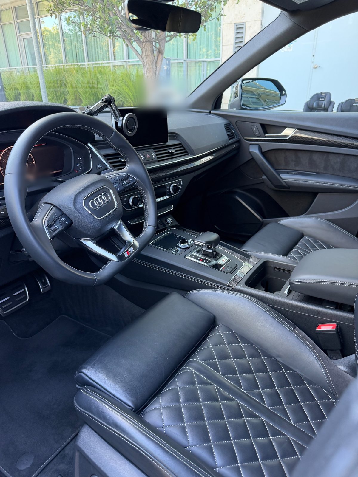 Interior of an Audi SQ5 after a full interior detail, with clean leather, wheel and mats