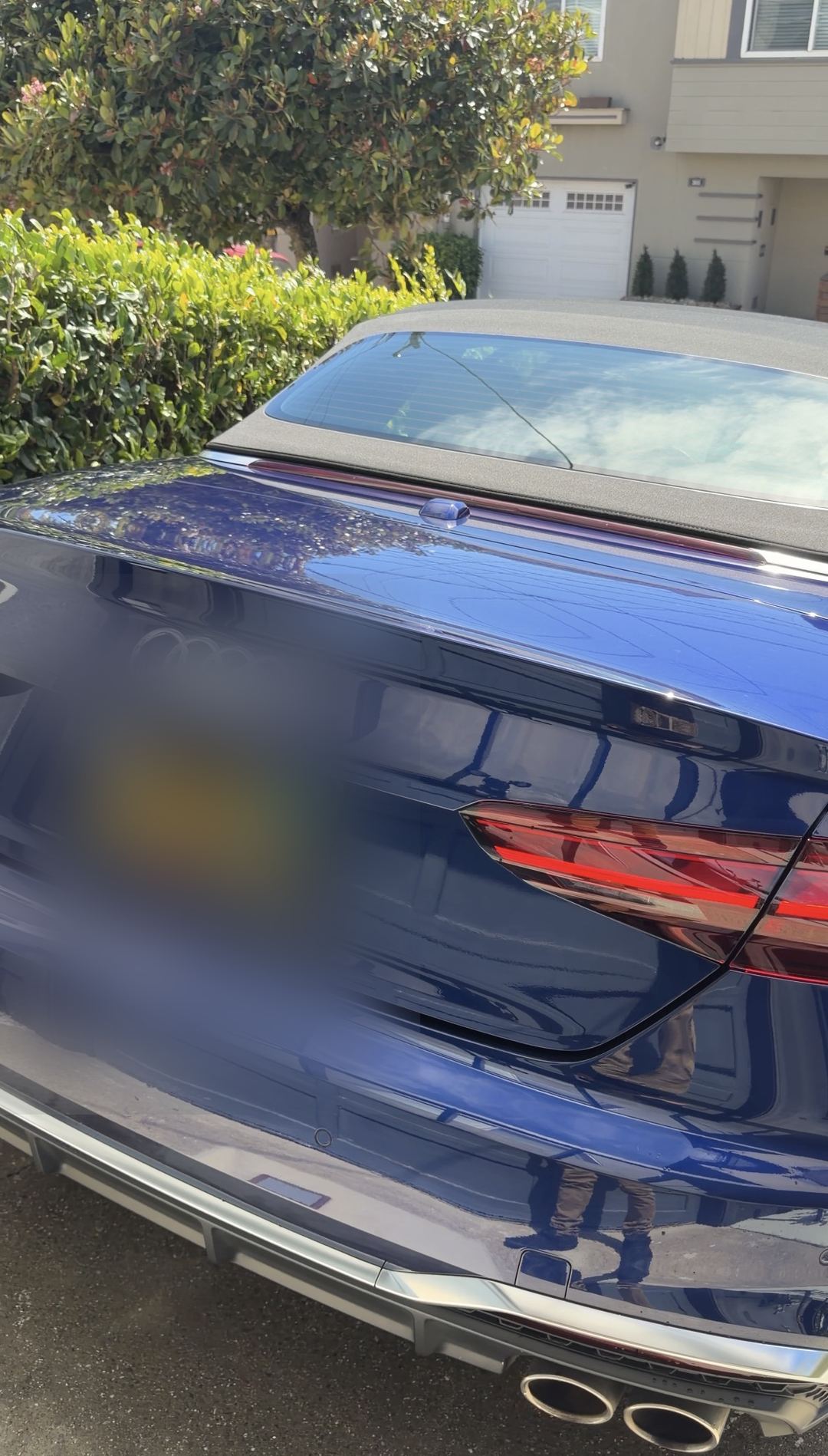 Rear of a clean blue Audi S5 Cabriolet with quad exhaust tips