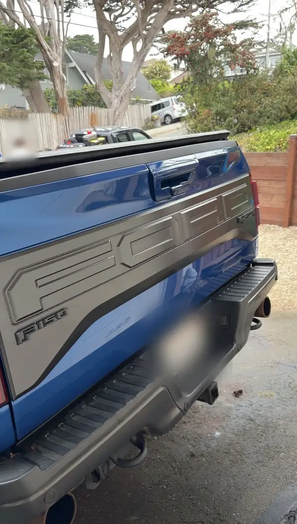 Clean rear bumper and tailgate of a Ford F-150 Raptor after a detail