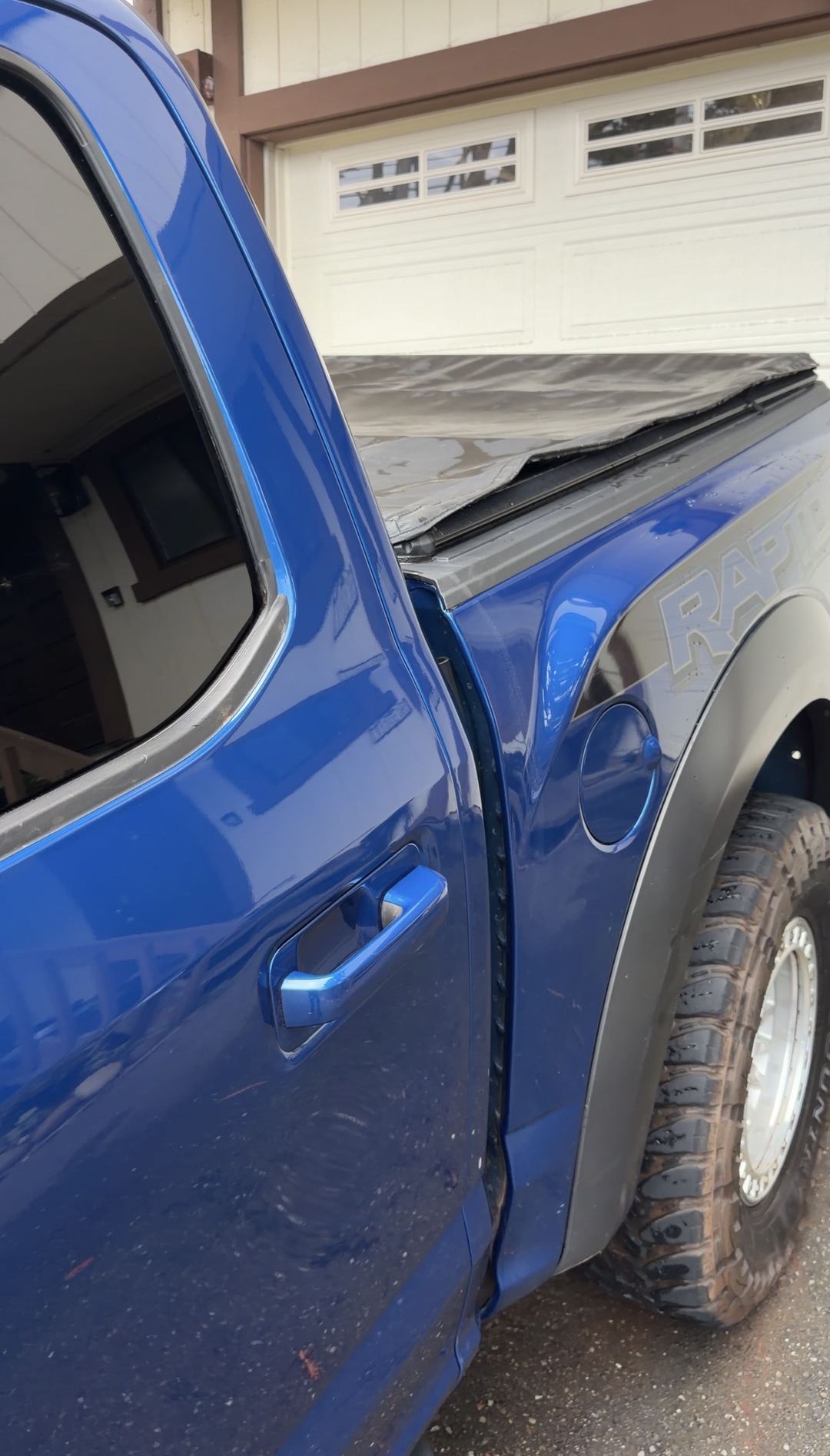 Clean rear door, fuel filler and RAPTOR bedside graphic on a Ford F-150 after detailing