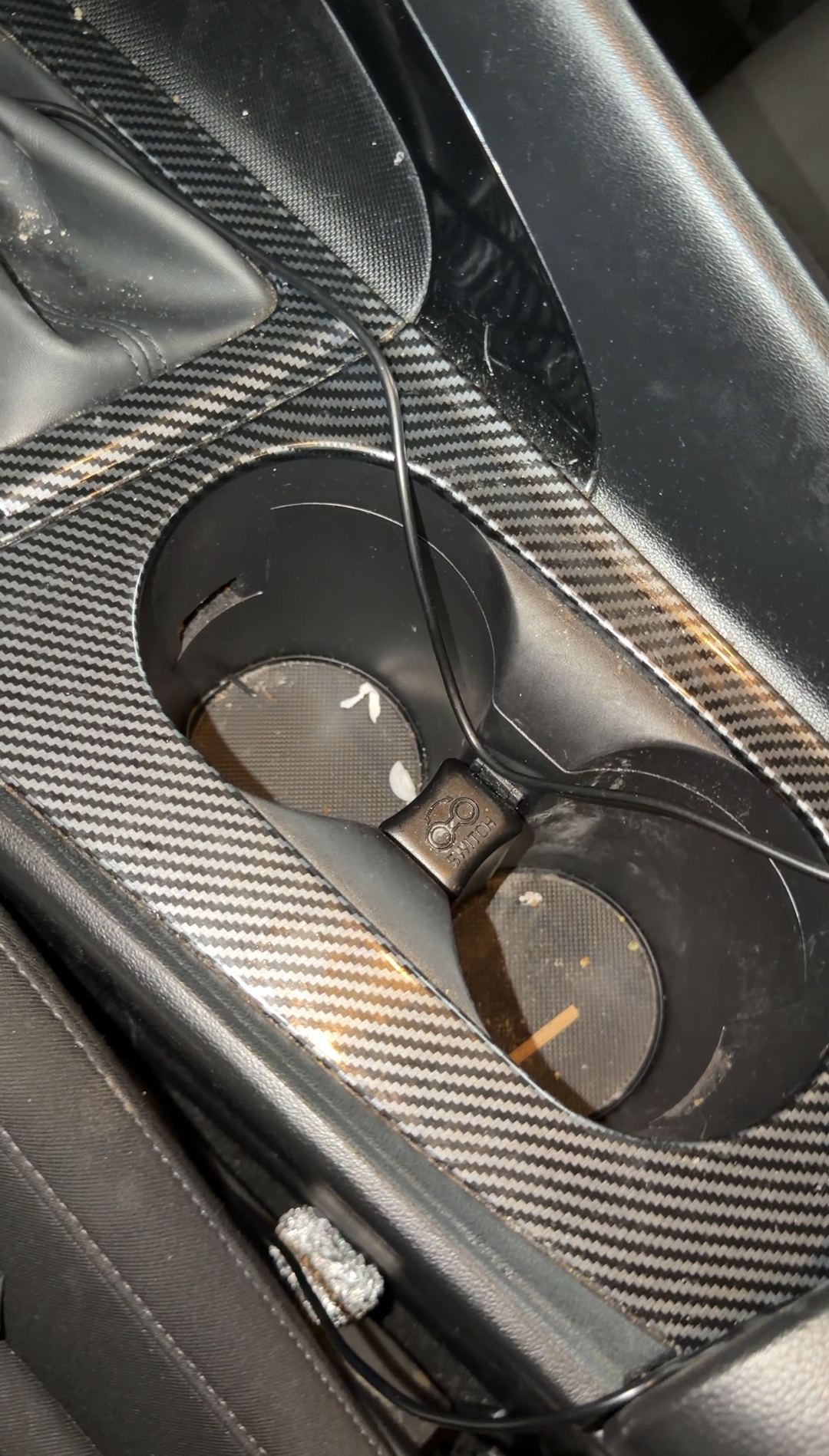 Hyundai Elantra cupholders with crumbs and debris before cleaning